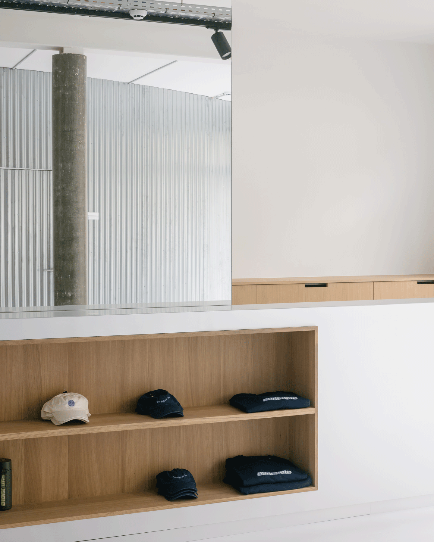 Low timber display shelf recessed into a white wall
