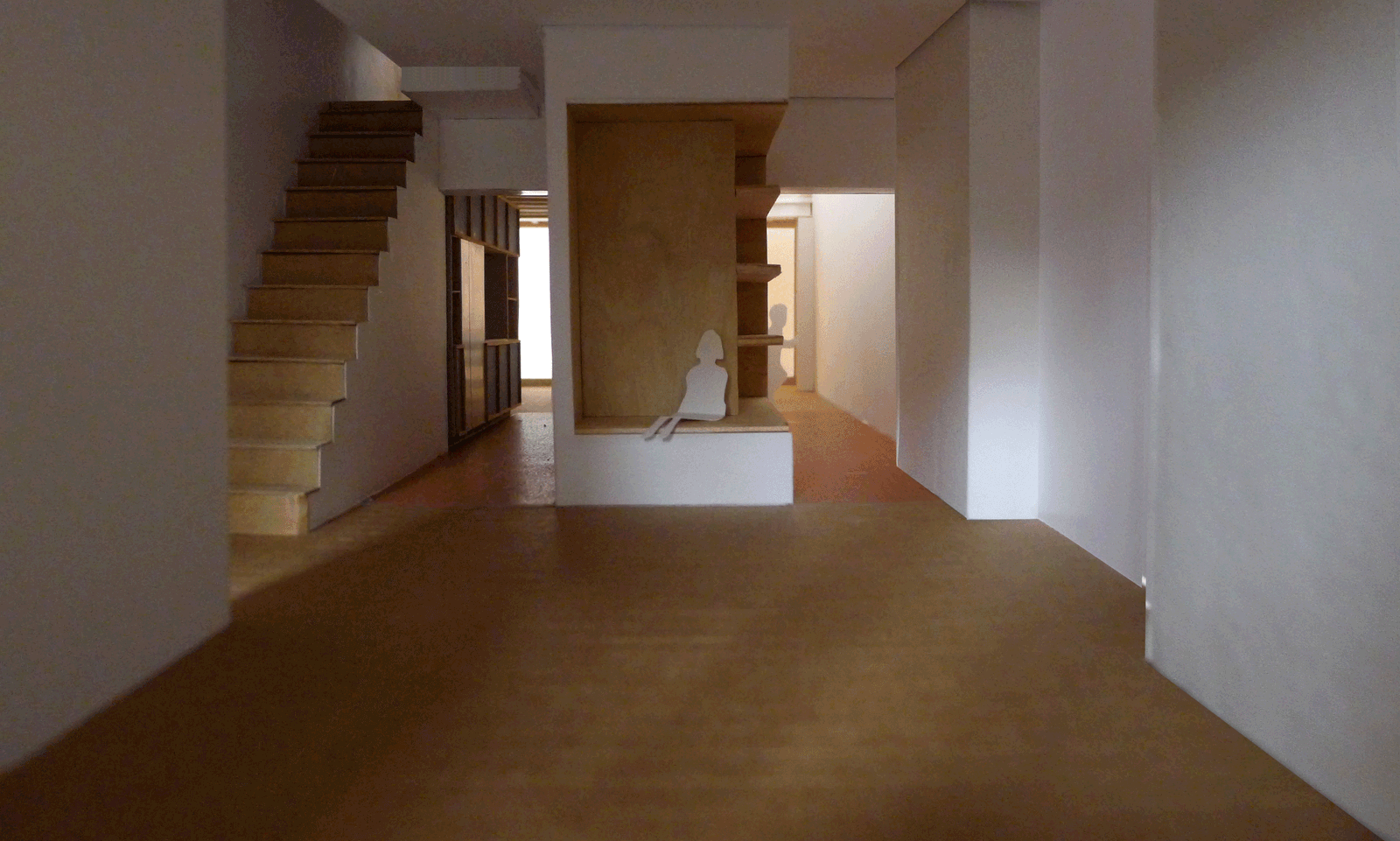 Unfinished long interior with a timber stair and built-in joinery