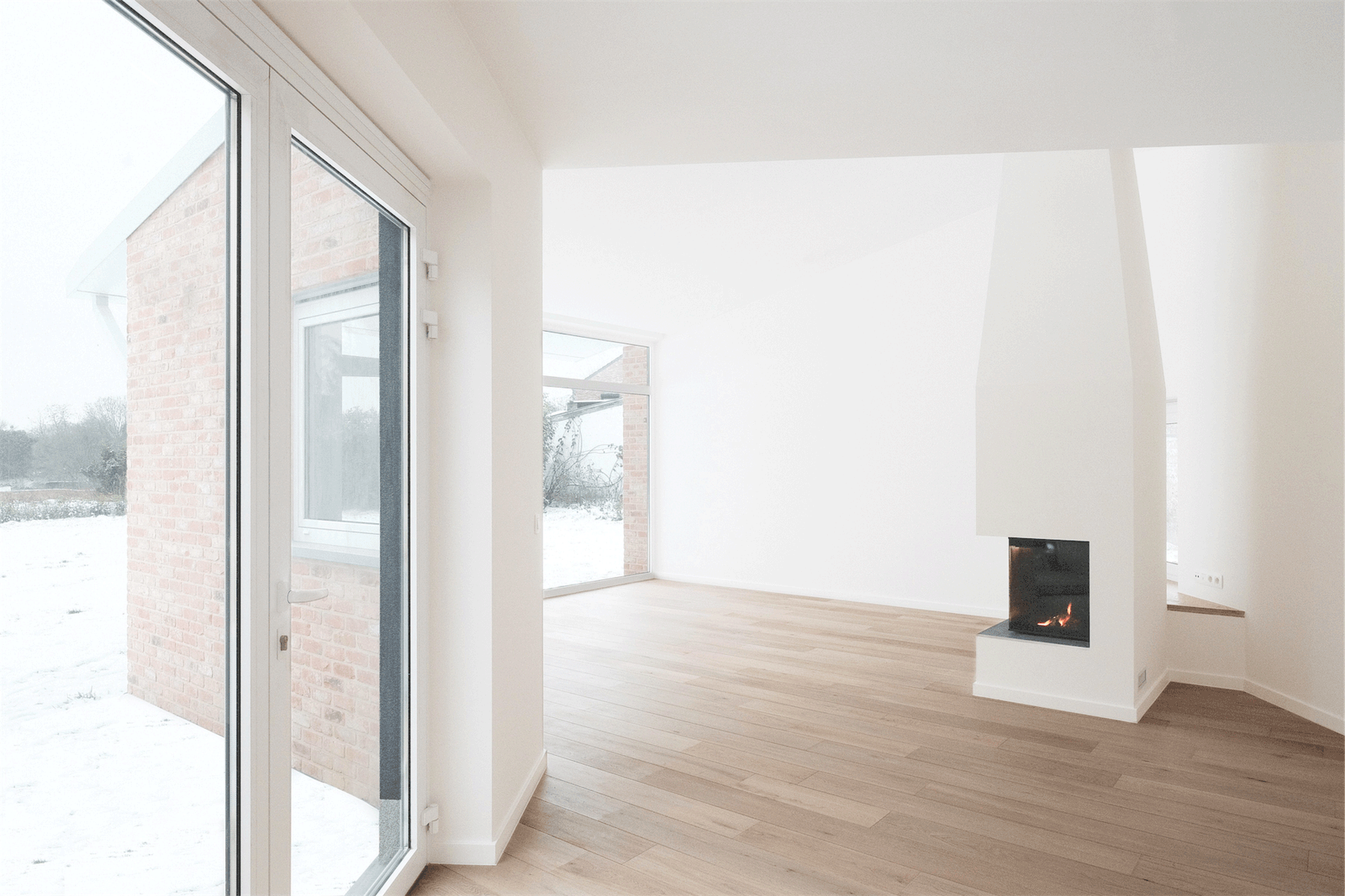 Living room with timber floor, fireplace and garden doors