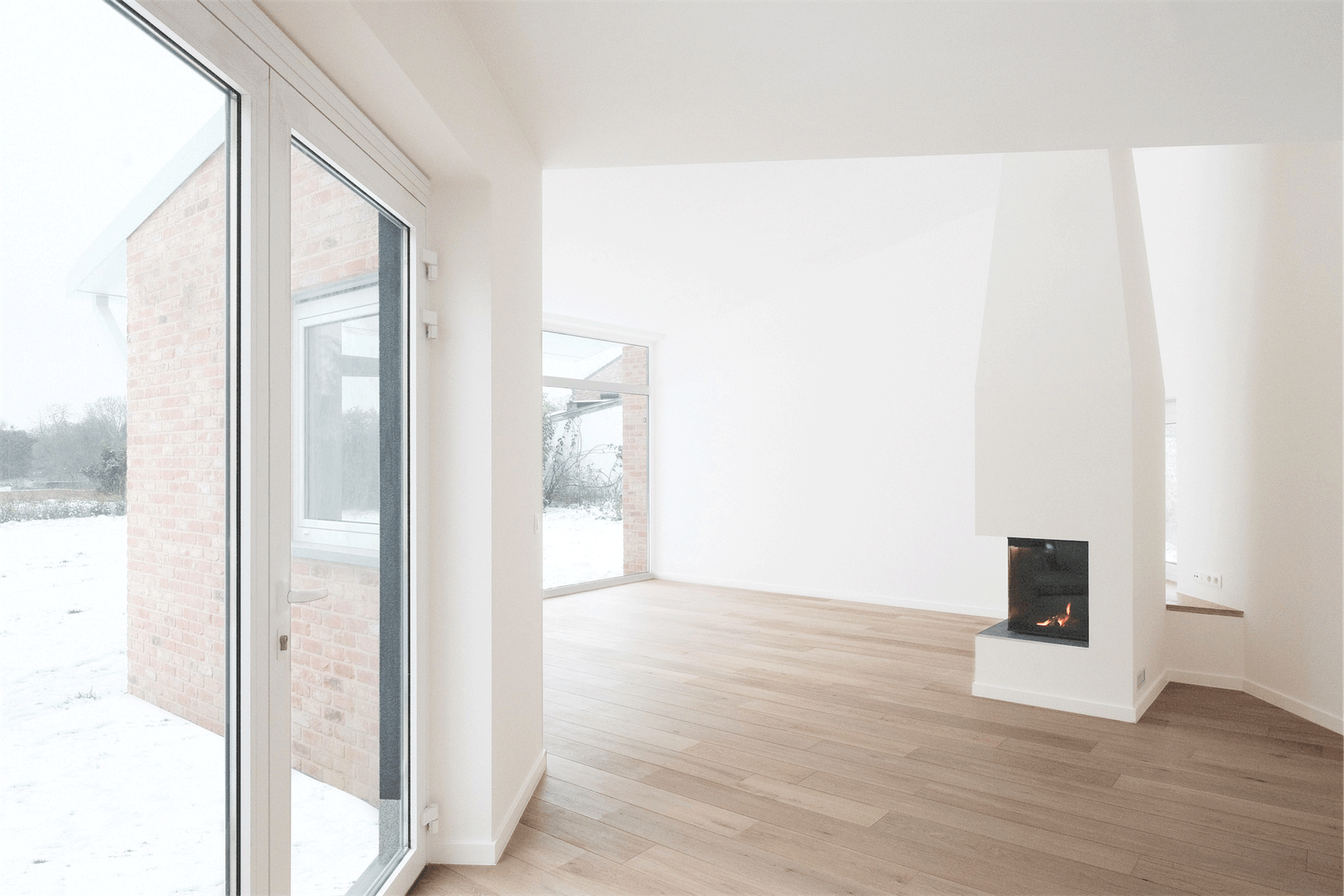 Living room with timber floor, fireplace and garden doors