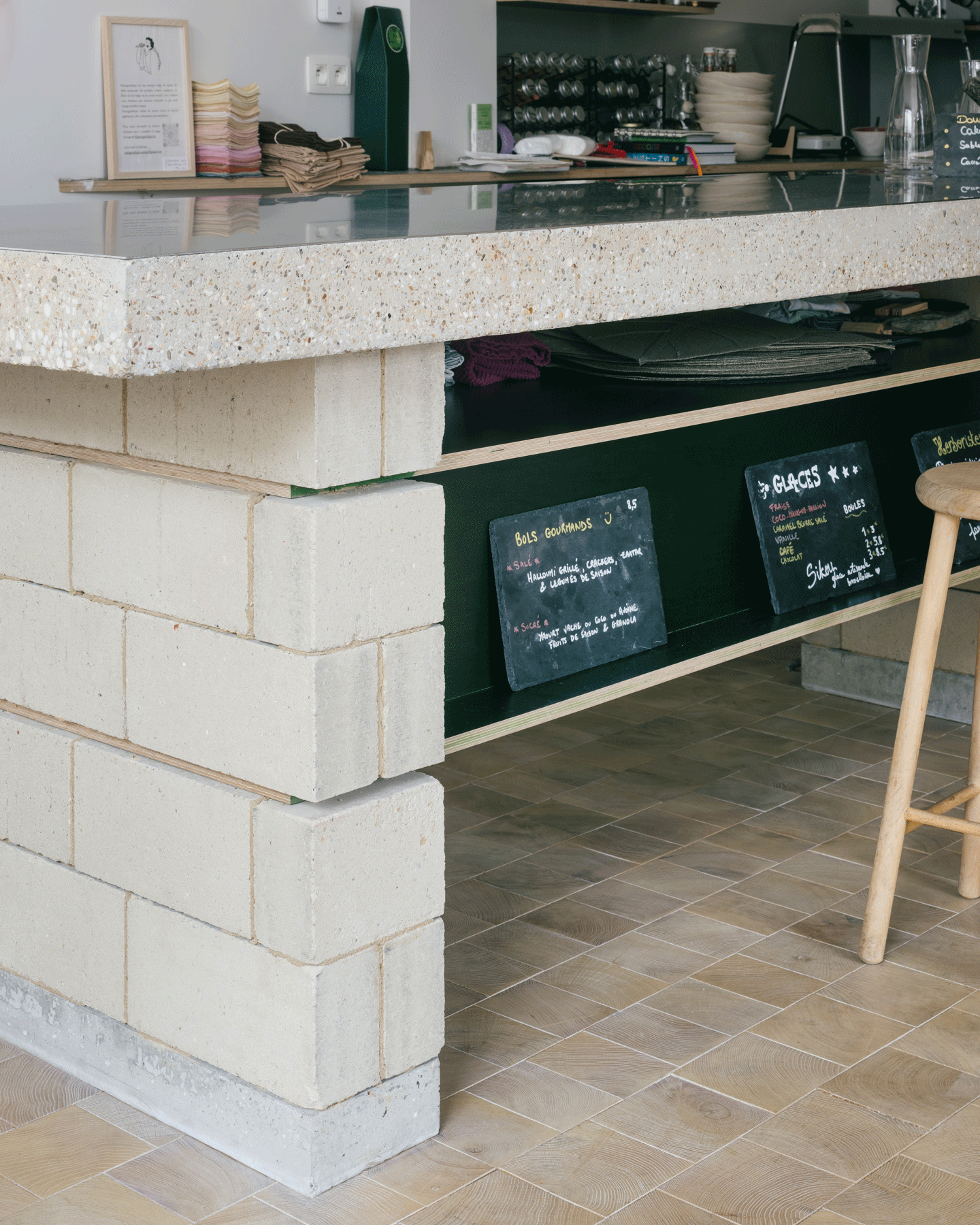 Close view of the terrazzo counter, menu boards and timber stool