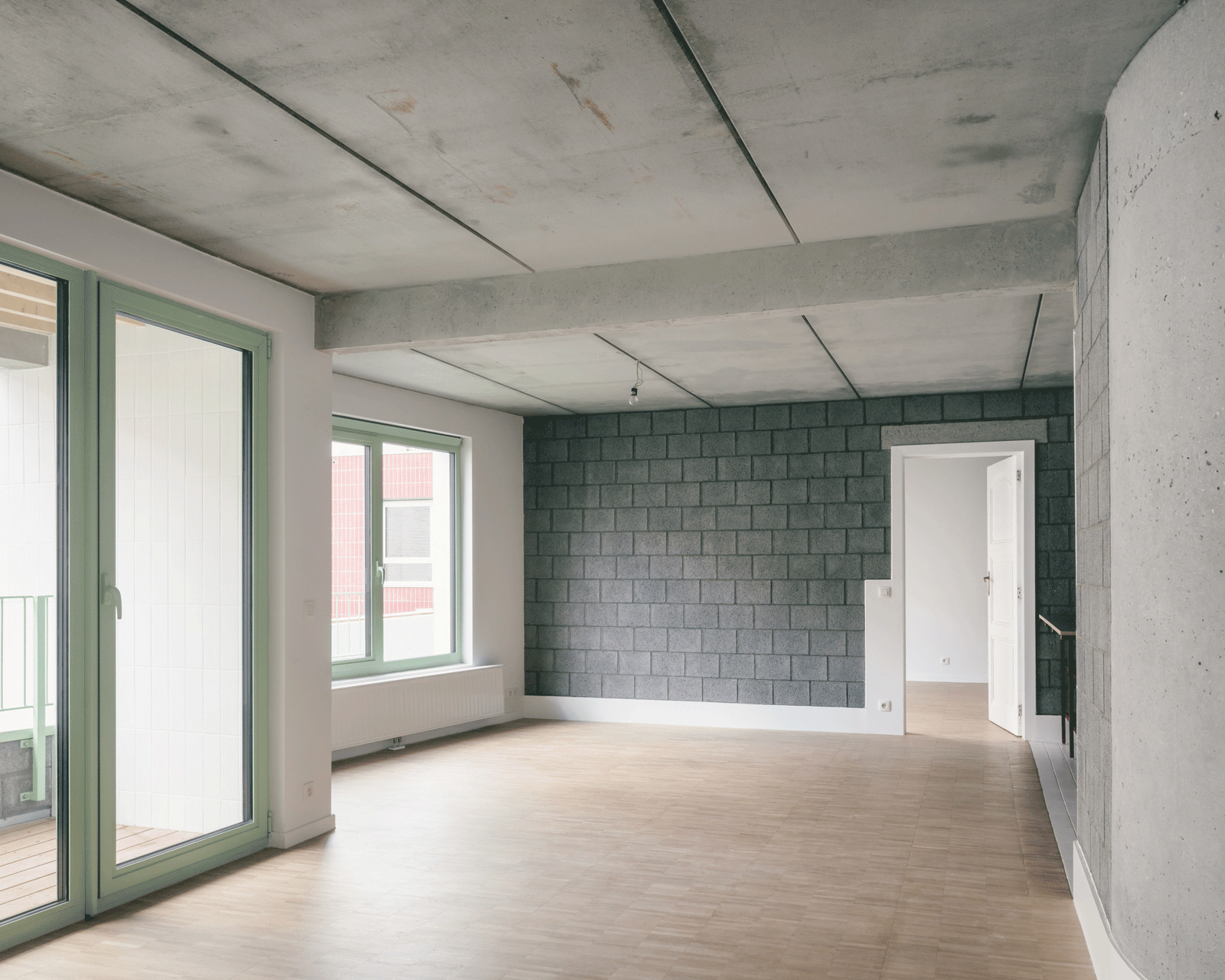 Unfinished room with concrete ceiling, block wall and garden doors