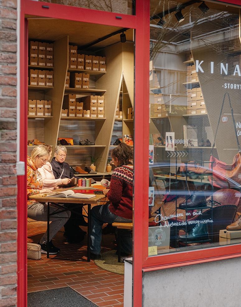 Workshop visible through the red-framed shopfront