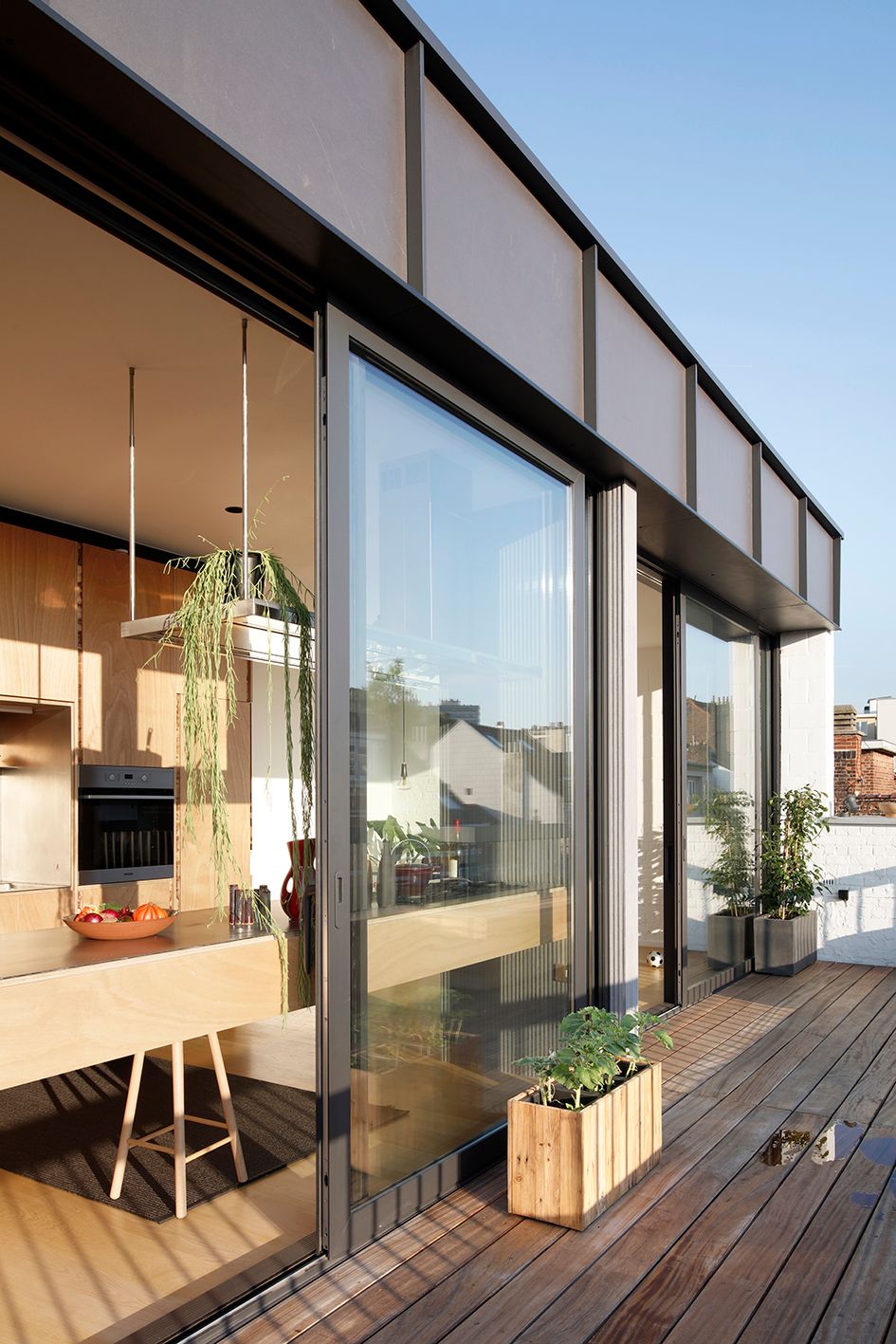 Rooftop terrace beside full-height folding glass doors