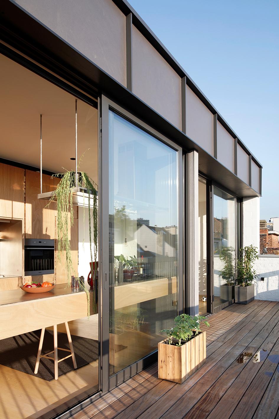 Rooftop terrace beside full-height folding glass doors