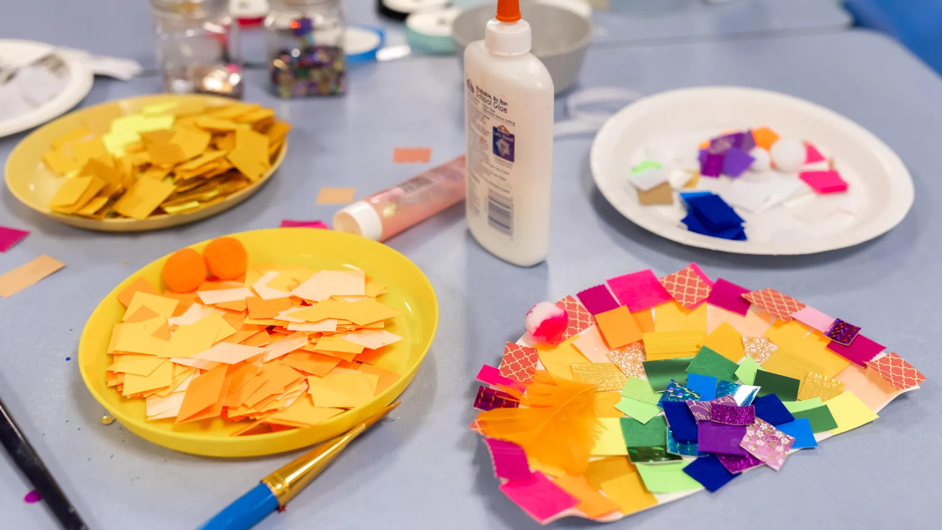 A photo of some painting supplies in the shape of a rainbow.