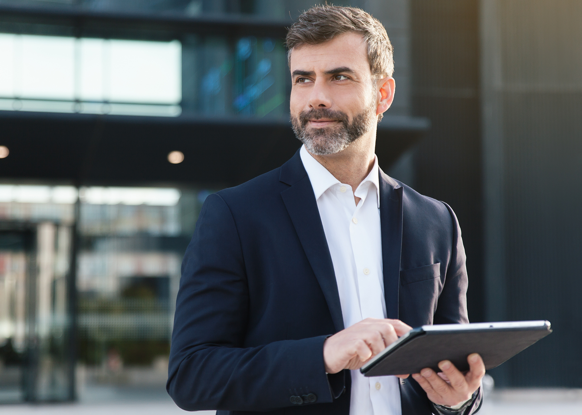 Man in suit working on an iPad
