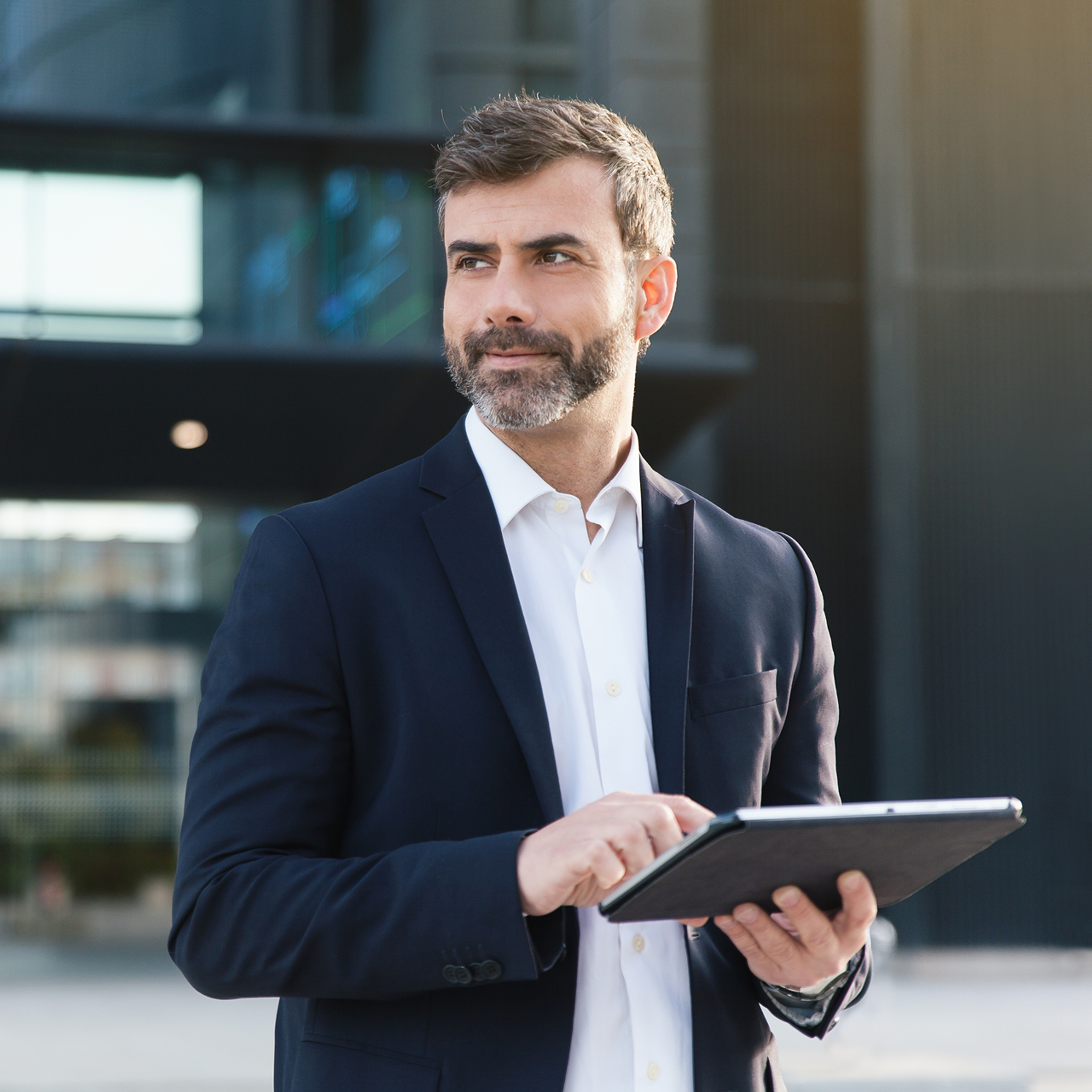 Man in suit working on an iPad