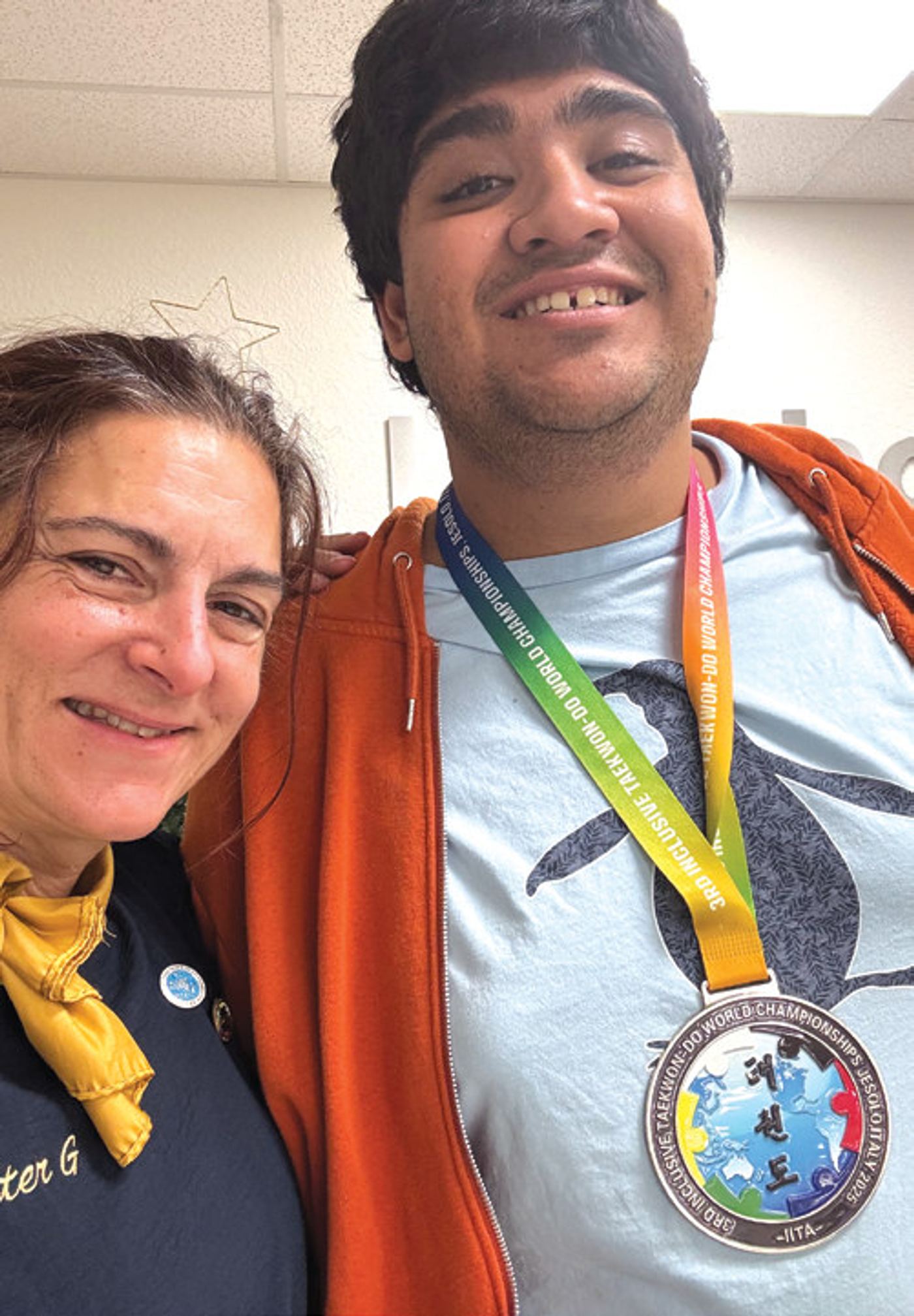 Several martial arts students who study with Michelle Golino-Crisco show off their medals and trophies. Michelle, better known as Master G, runs a nonprofit that offers martial arts training for all ages and abilities.