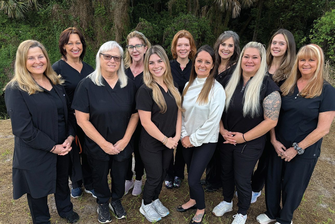 Dr. Mary Isaacs (far left), Dr. Kathryn Miller (back, center) and the Artisan Dental team