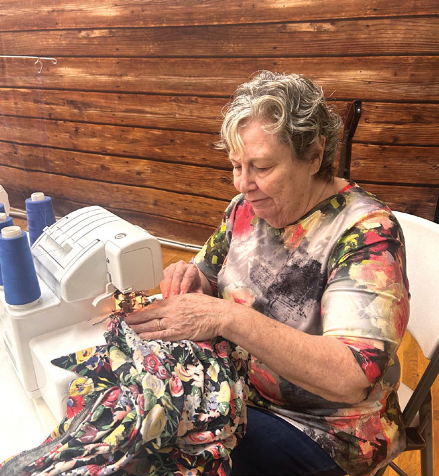 Carol Waszura, a Casselberry resident and clothing swap volunteer, mends clothing for attendees.