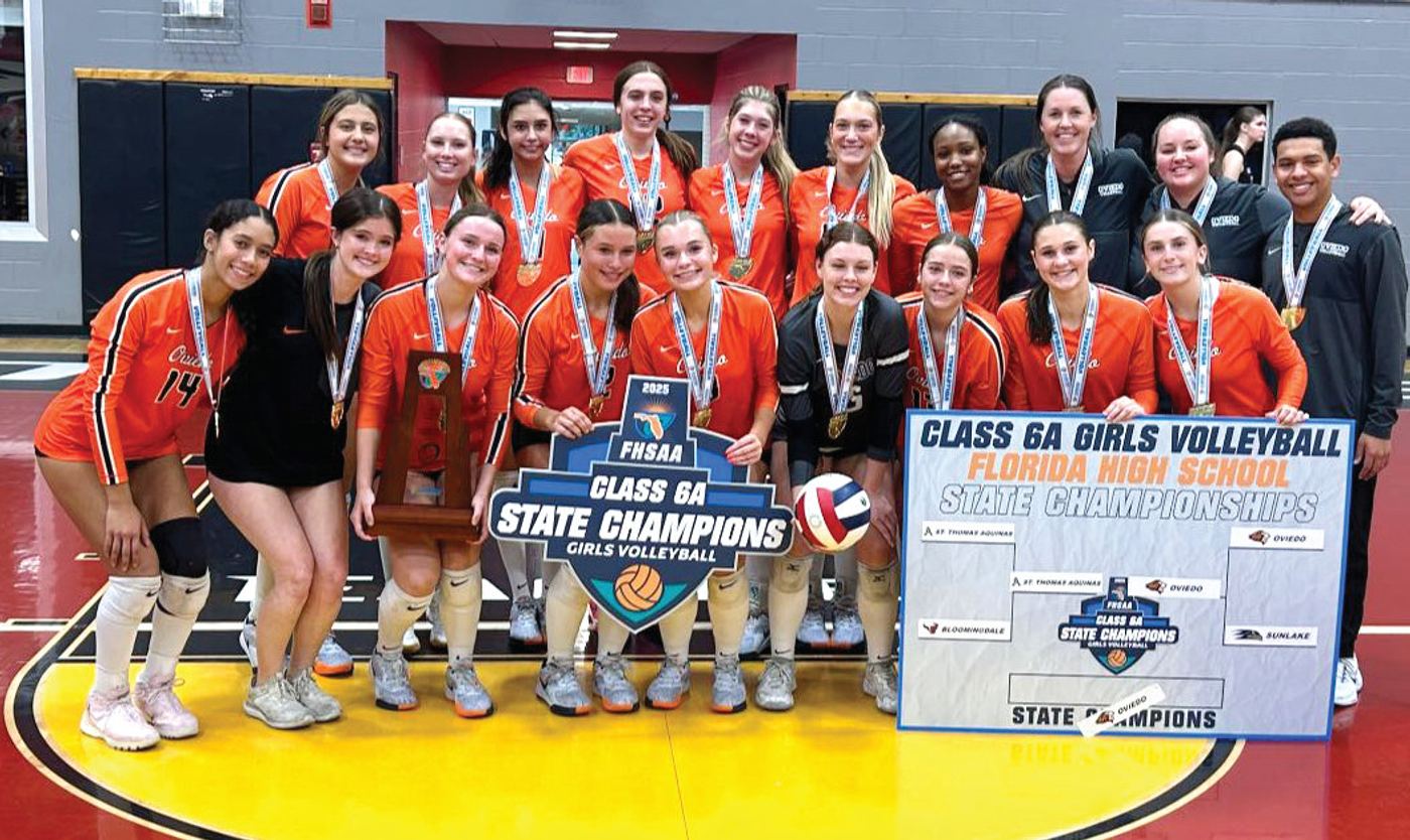 ^ The Oviedo High School girls’ volleyball team won the FHSAA Class 6A State Championship in November. < Oviedo High School volleyball star Delaney Sloane and Coach Jen Darty celebrate their state title.