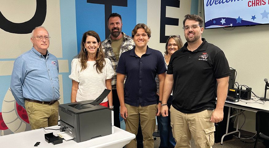 Front row: Rich Wagers, senior IT technician; Supervisor of Elections Amy Pennock, student Ethan Sigal, and teacher Christopher Endress. Back row: Ethan’s parents, Alex Sigal and Rachel Bland