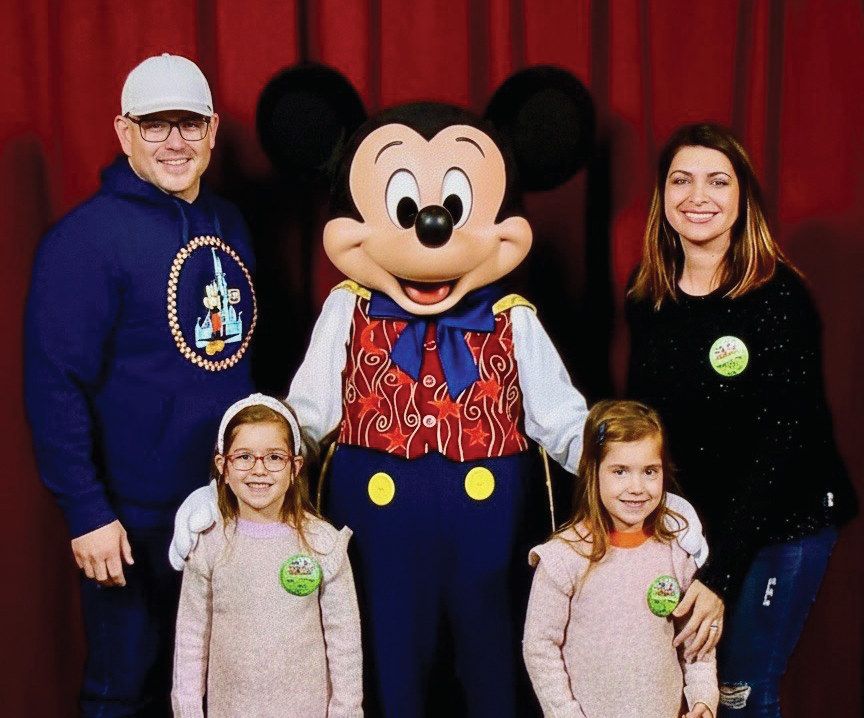 Adam Fox, owner of Fox Estate Buyers, with his wife Flora, daughters Ava and Alexandra, and Mickey Mouse