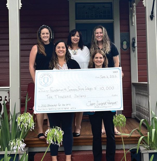 Sanford Porchfest cofounders Shelly Allen, Nancy Sepulveda, Shana Gorondy, and Kim Waters present a $10,000 check to Dr. Michele Cuomo, dean of arts and communications at Seminole State College.