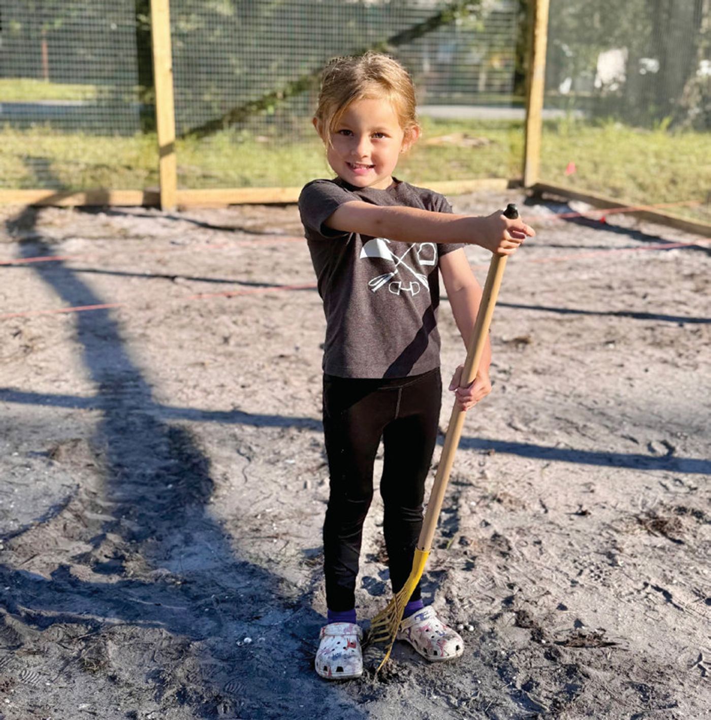Five-year-old Mackenzie Nall helps in the garden.