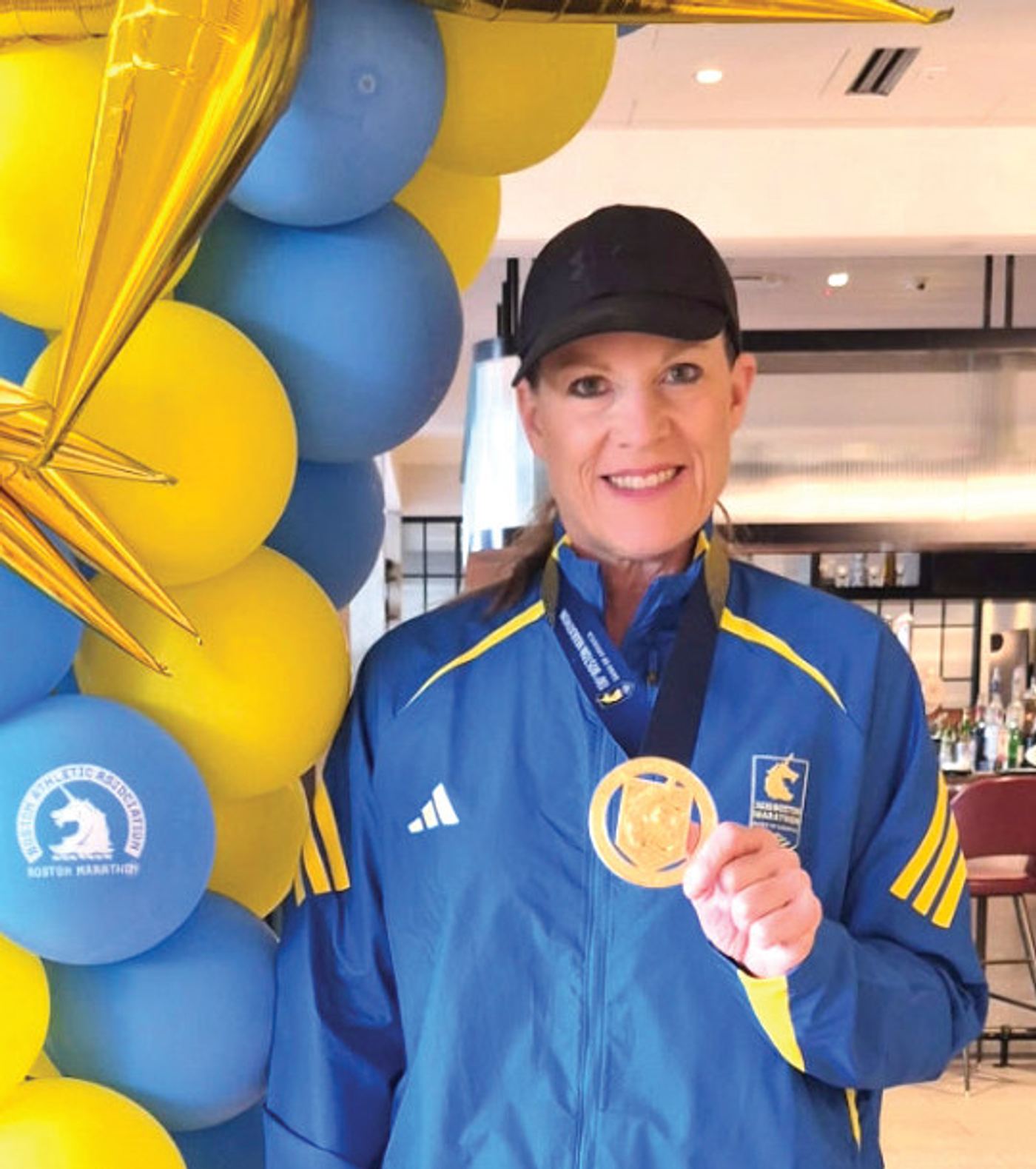 Cheryl with her medal from the Boston Marathon