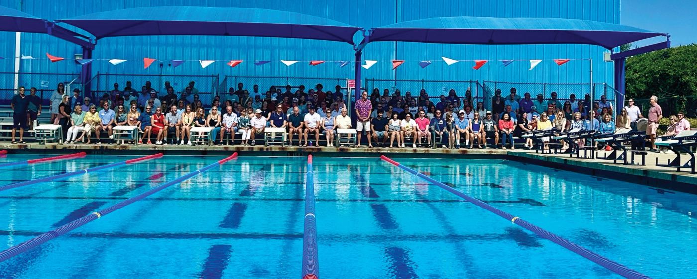 Lake Brantley’s longtime swim coach, Clay Parnell (center, standing), at a surprise celebration thrown in his honor at the school’s pool. Clay is now retired and was recently inducted into the school’s Athletic Hall of Fame.