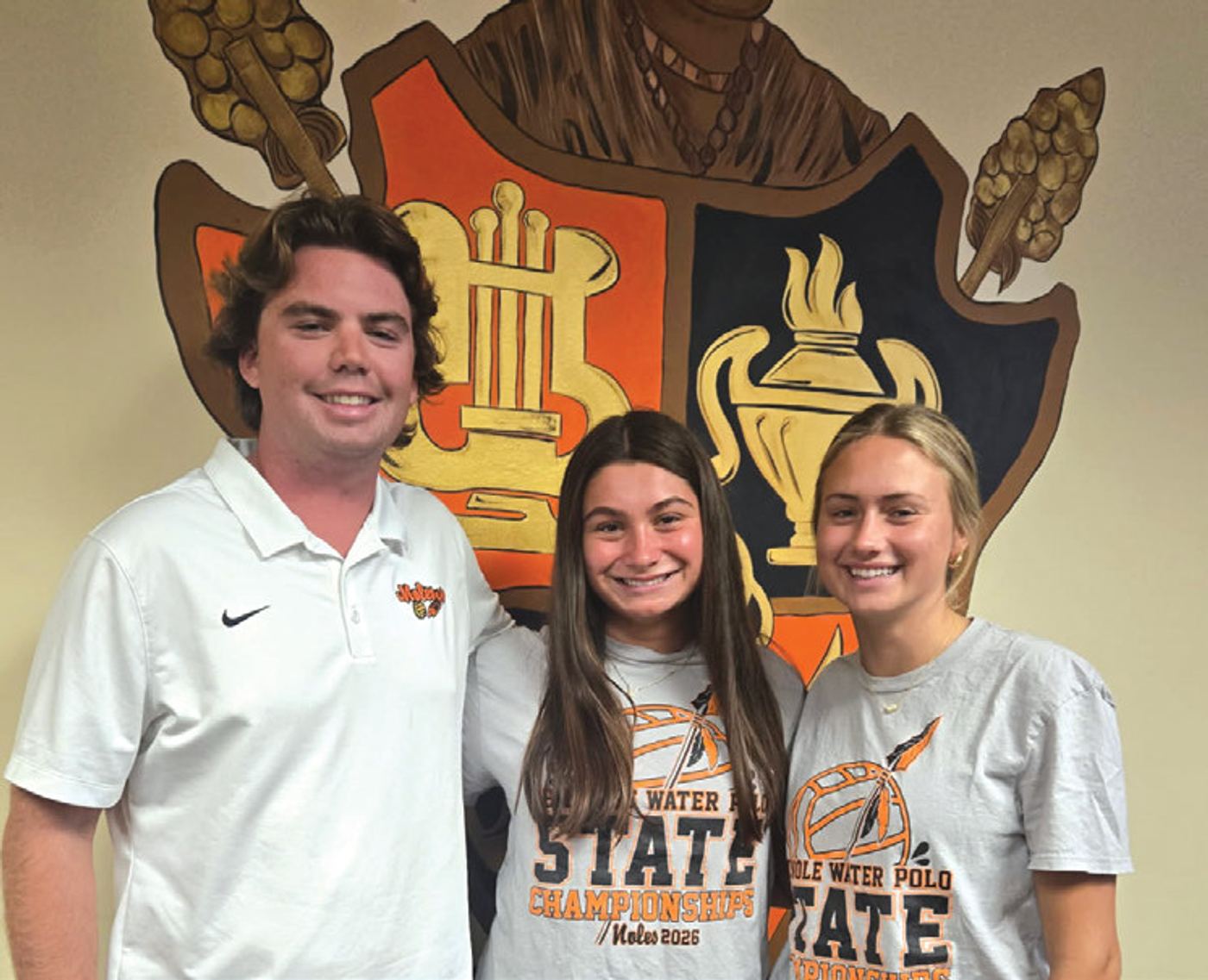 Coach Ryan Ackerson with players Vivian Swain and Halle Zimlich