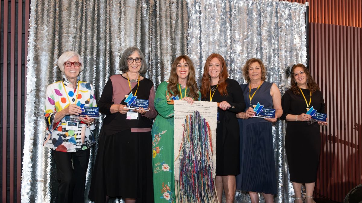 The six Choices 2024 honorees on stage holding a woven tapestry