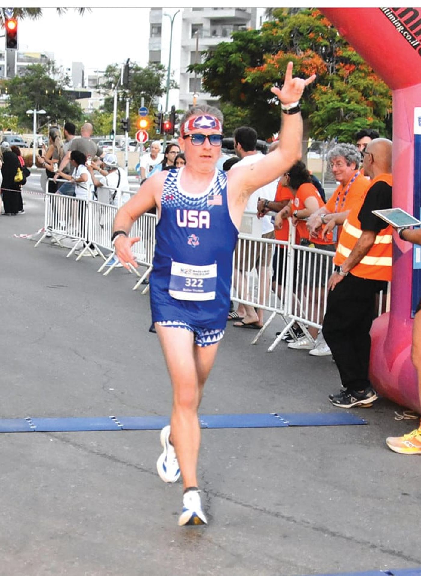 Tom Butler crossing the 5K finish line