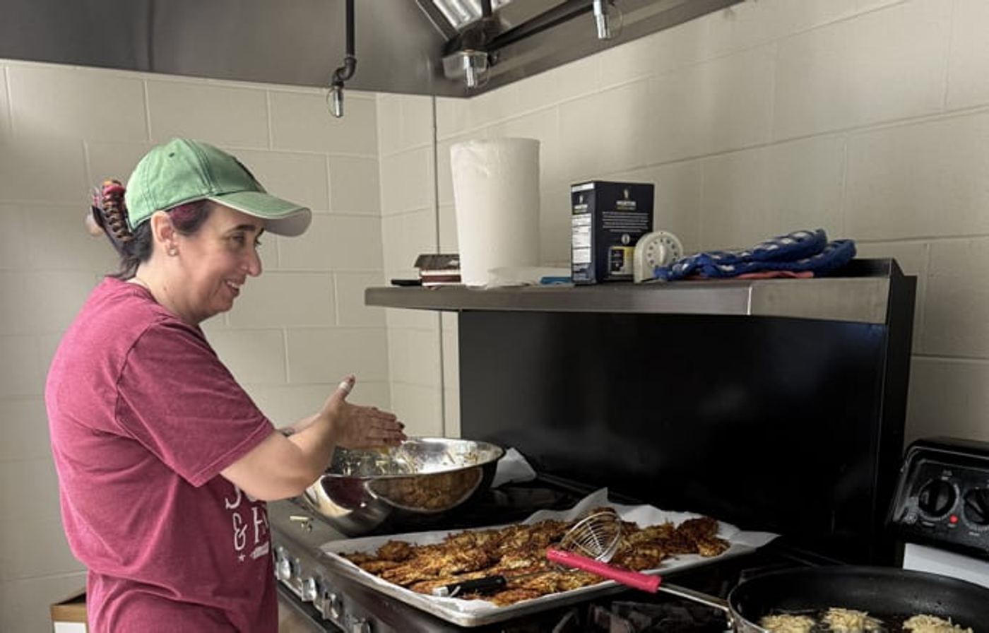 Amy Cores frying latkes