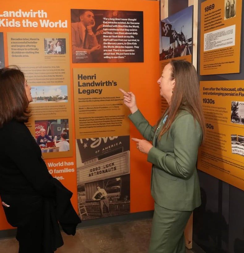 Visitors viewing the Henri Landwirth exhibit panels