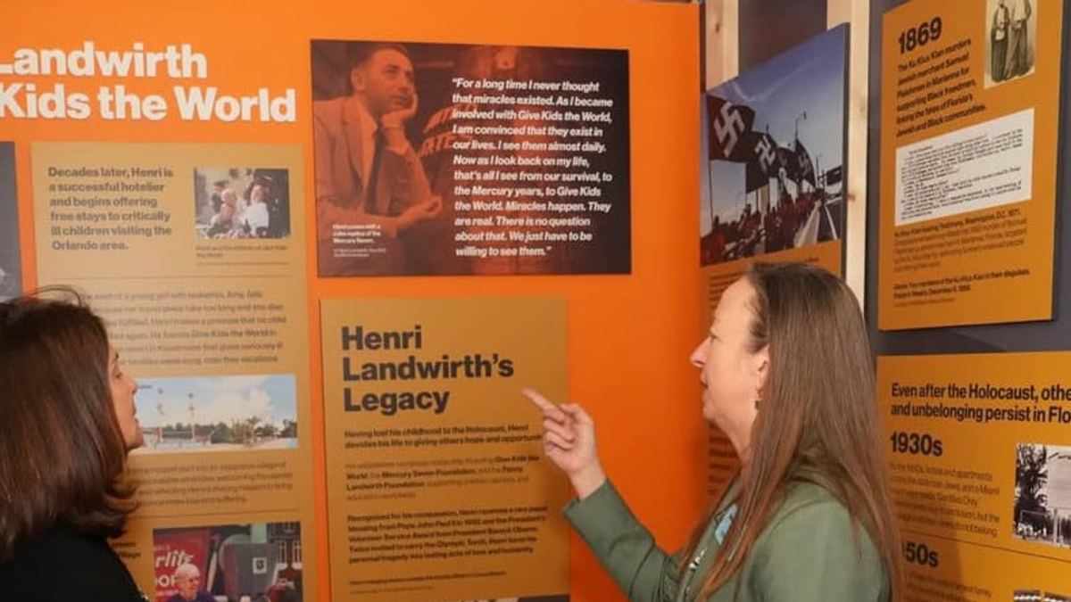 Visitors viewing the Henri Landwirth exhibit panels