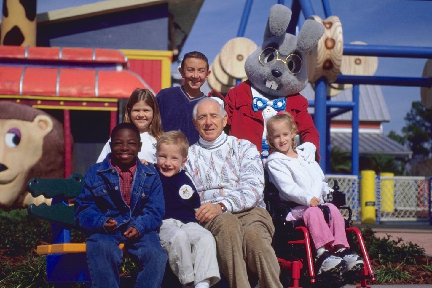 Henri Landwirth with children at Give Kids the World Village