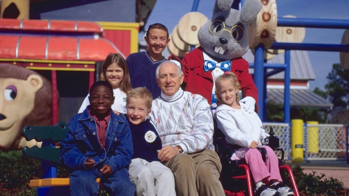 Henri Landwirth with children at Give Kids the World Village