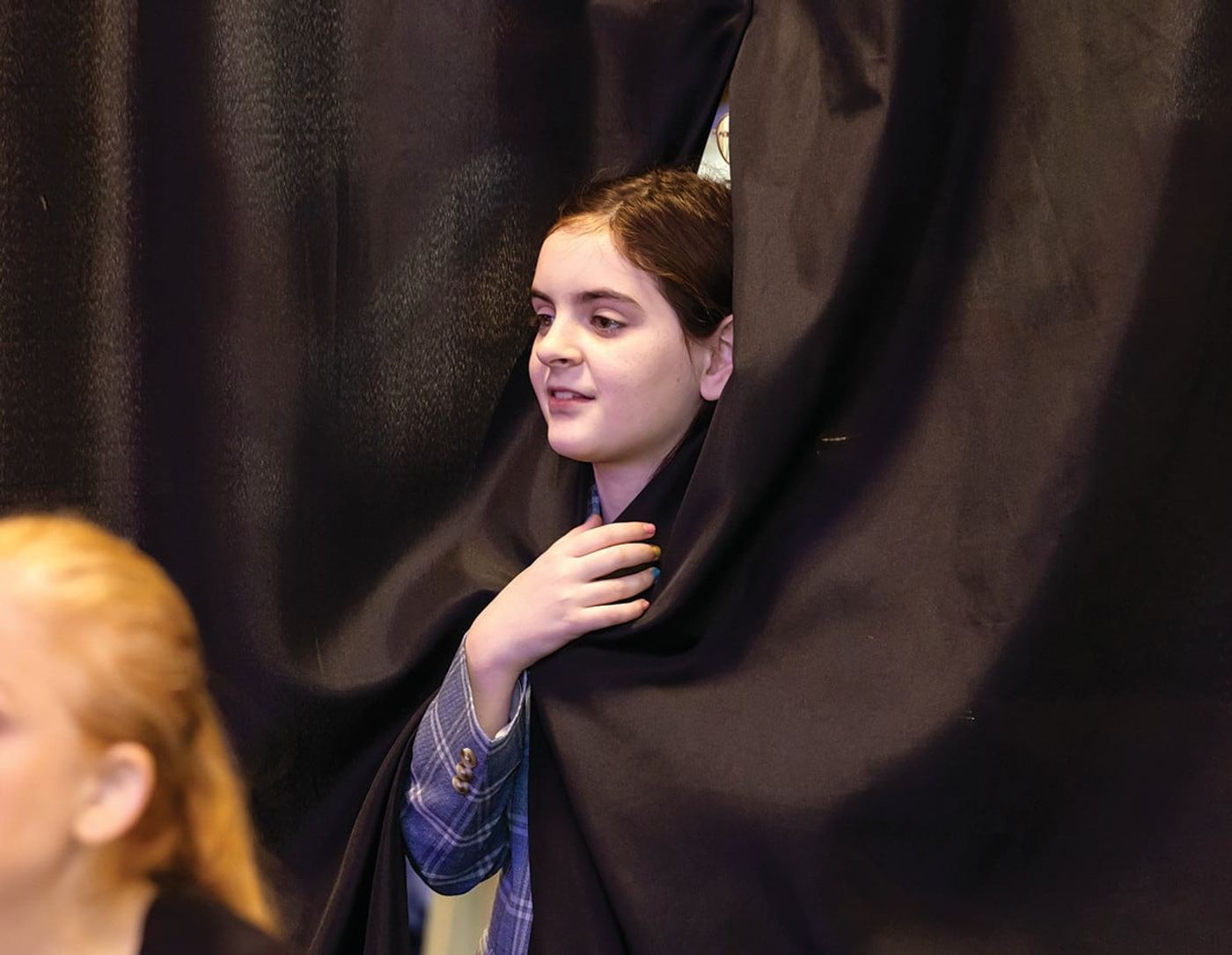 Billie peeking through the backstage curtain