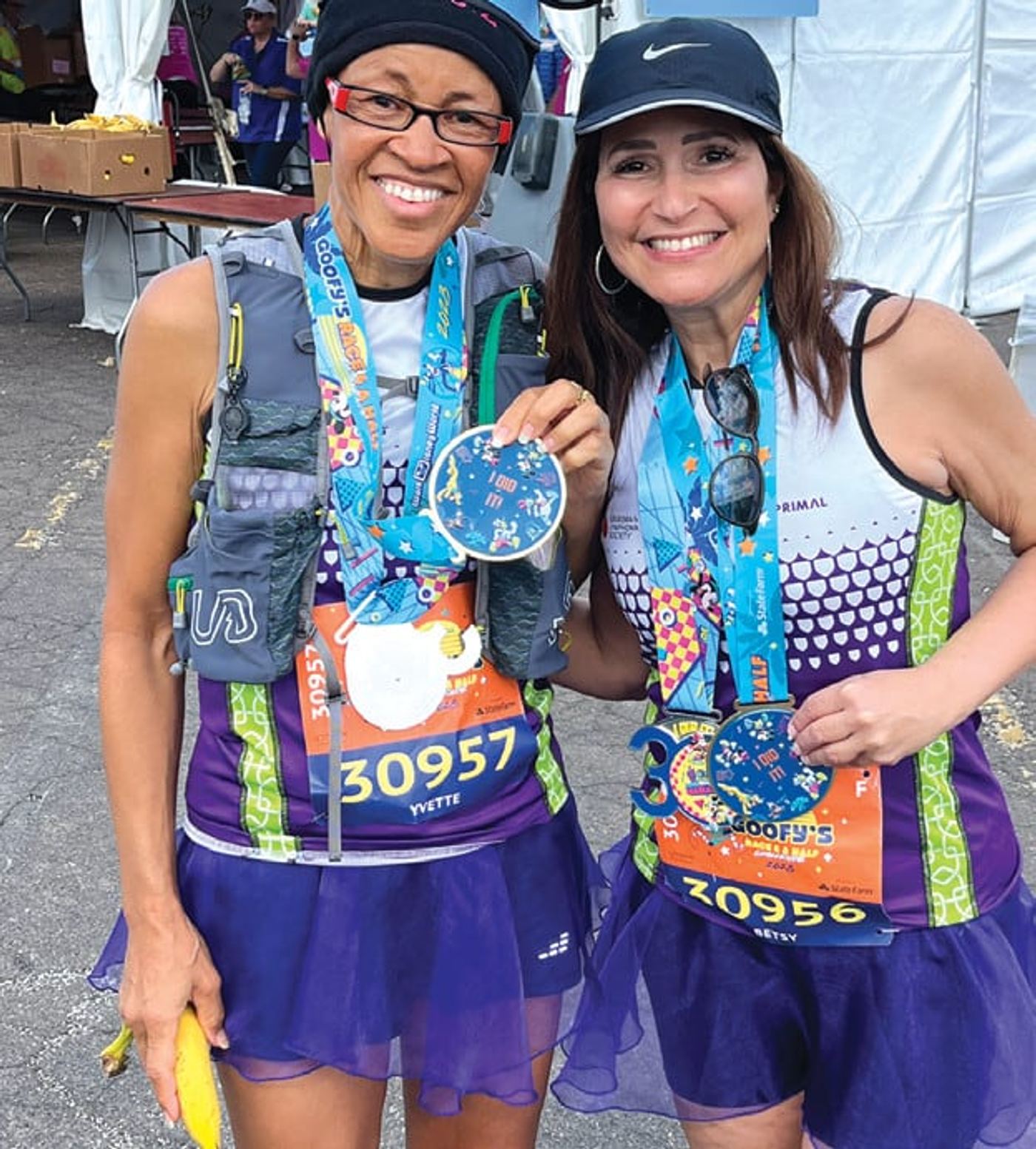 Betsy Cohen and a friend with their race medals