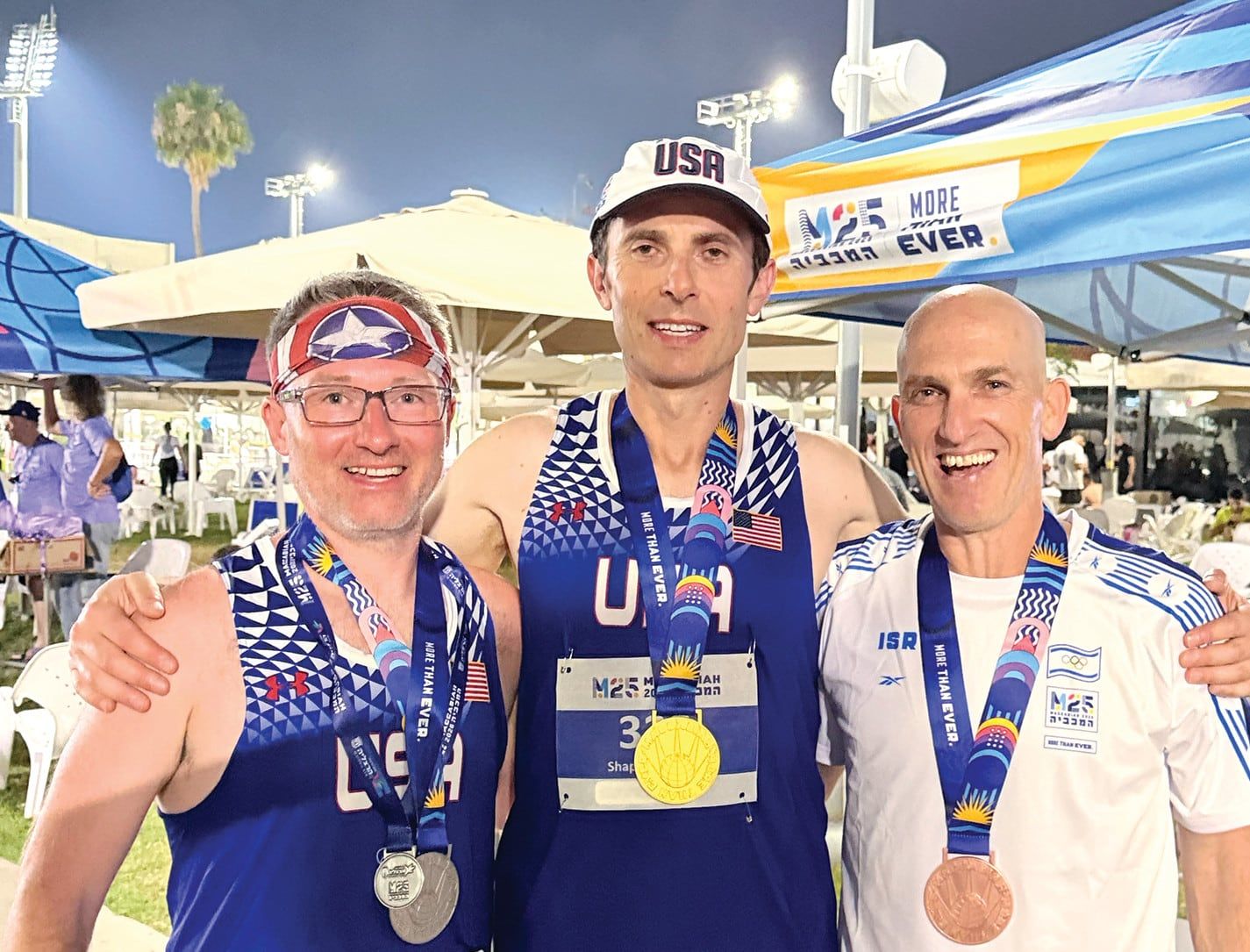 Tom Butler with Zory Shaposhnik and Meir Kaufman, wearing their medals