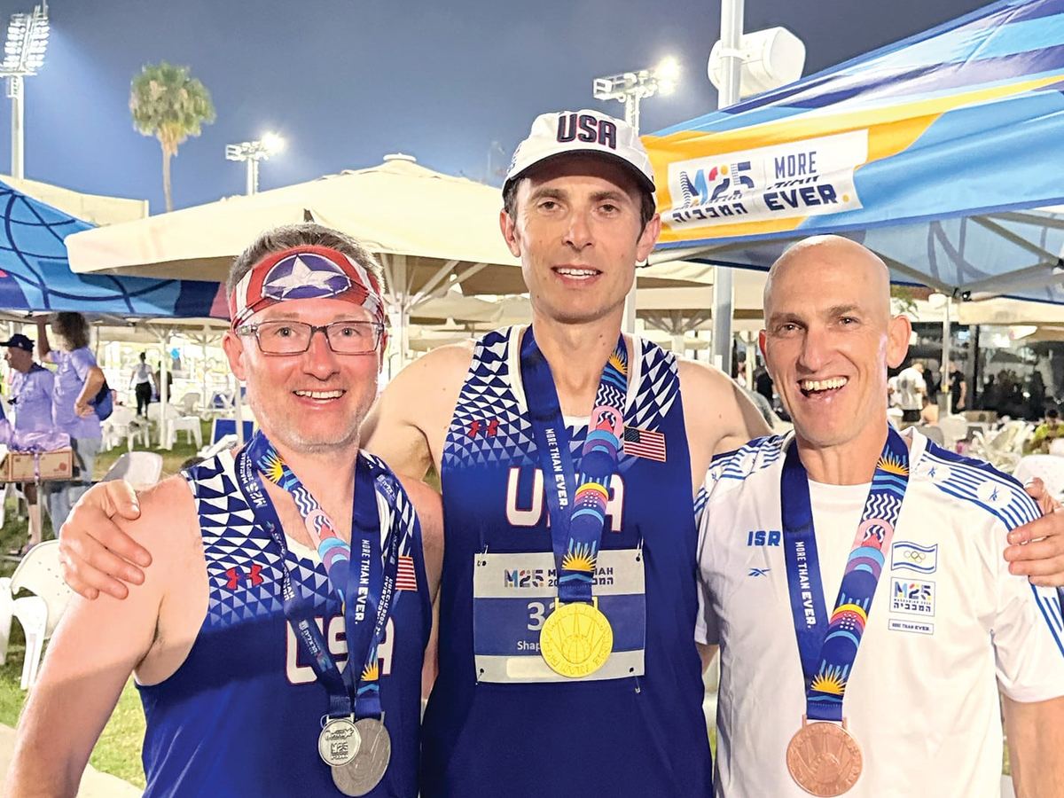 Tom Butler with Zory Shaposhnik and Meir Kaufman, wearing their medals