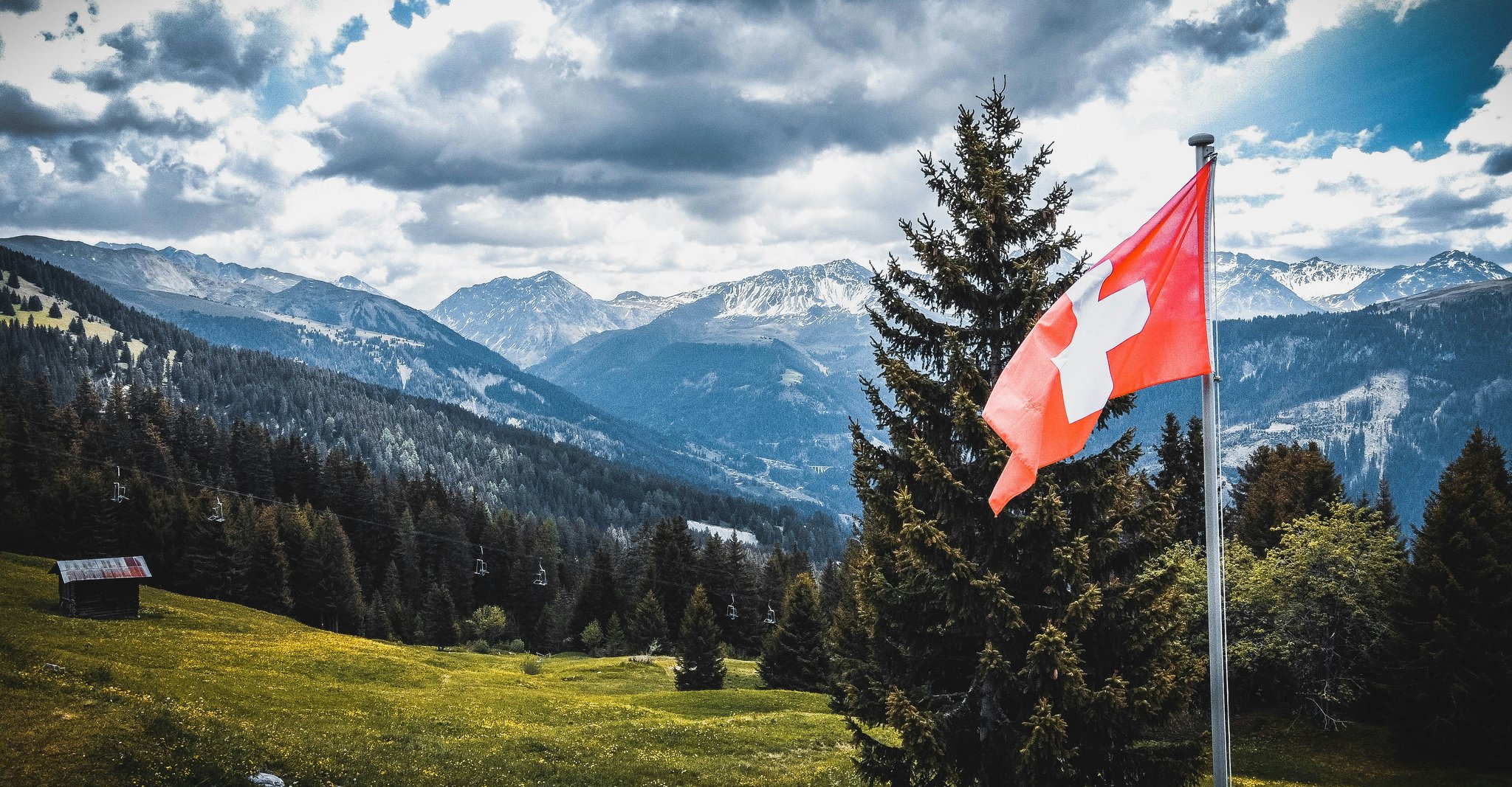 Swiss flag and a mountain background