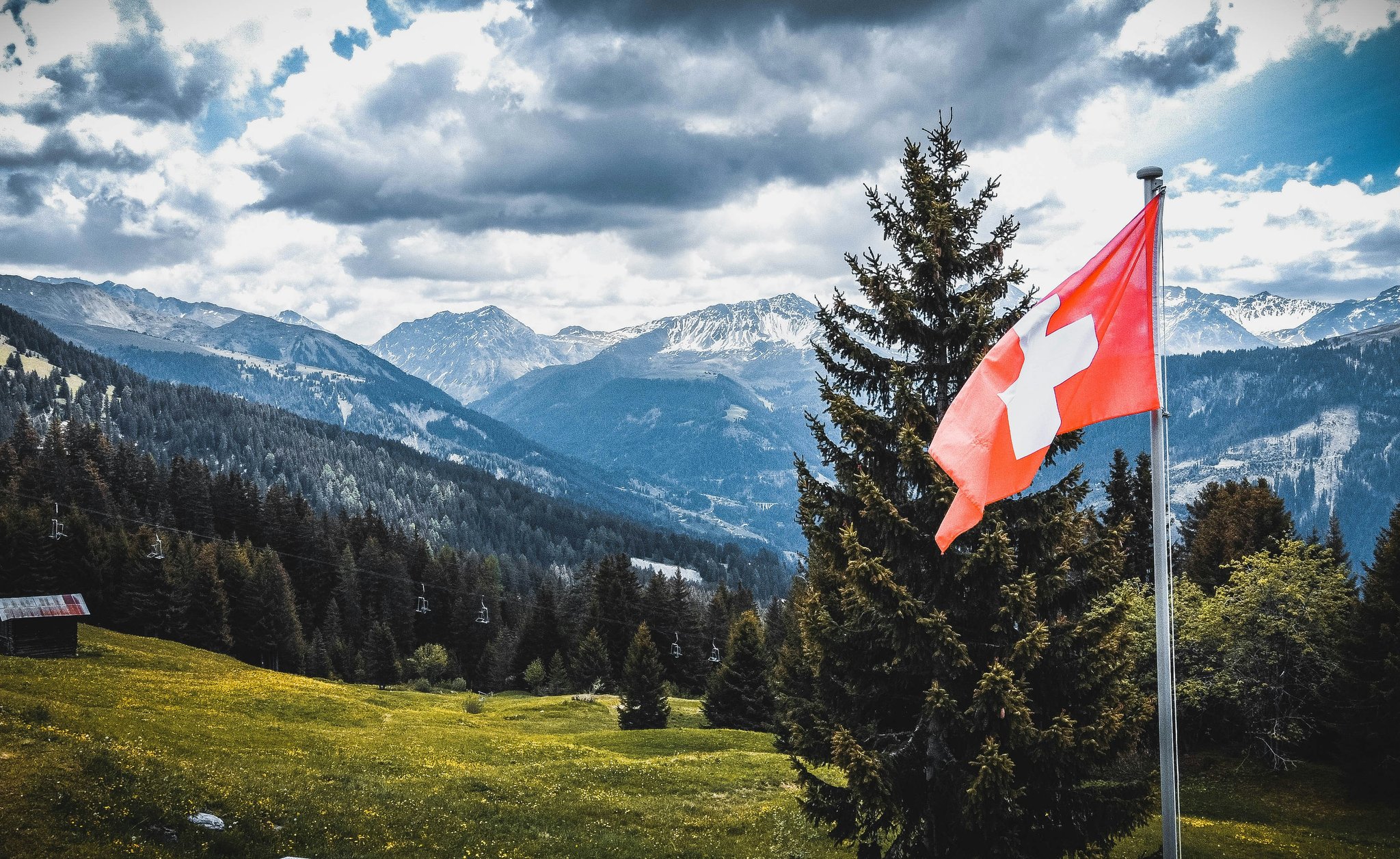 Swiss flag and a mountain background