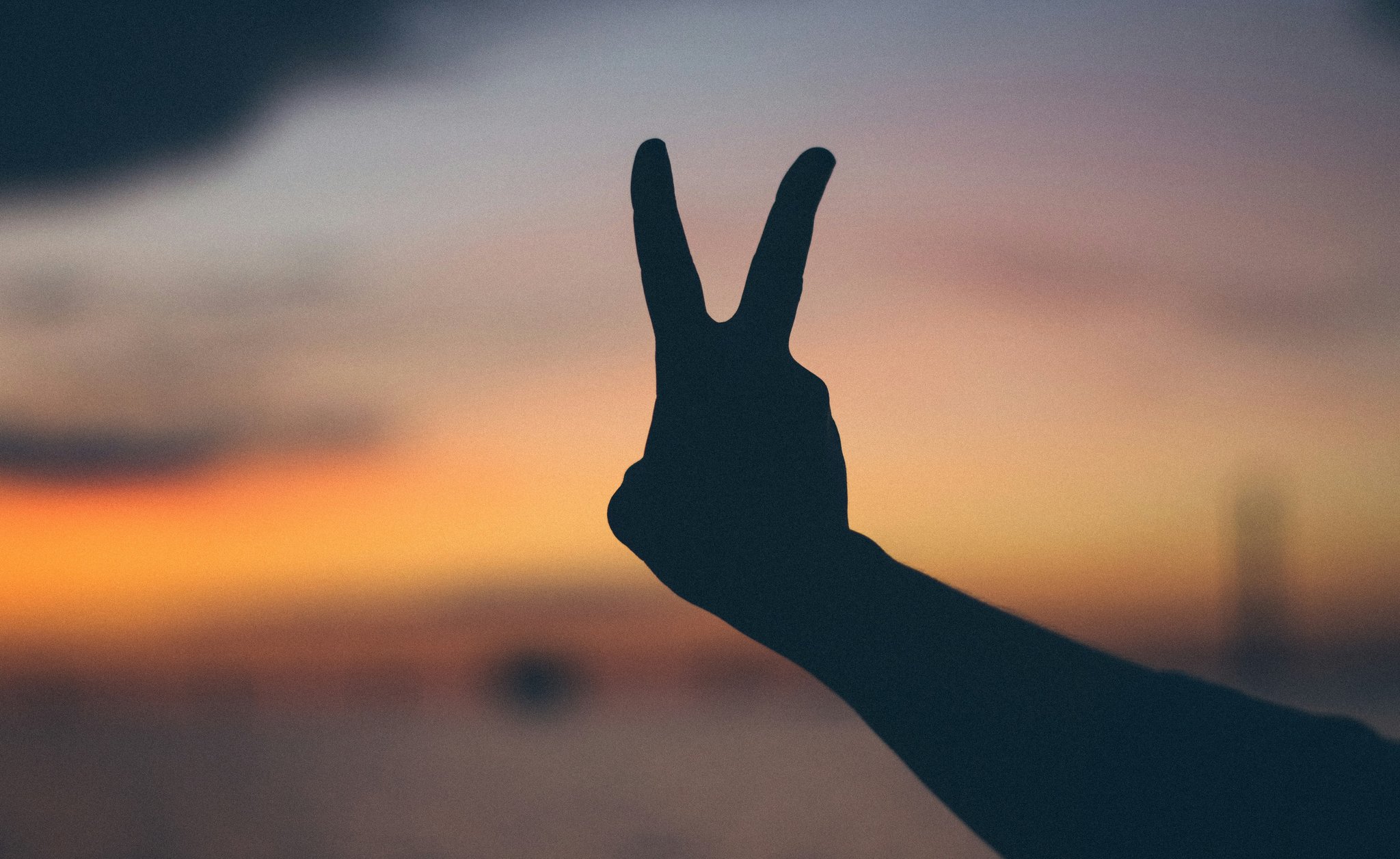 A hand holding 2 fingers up