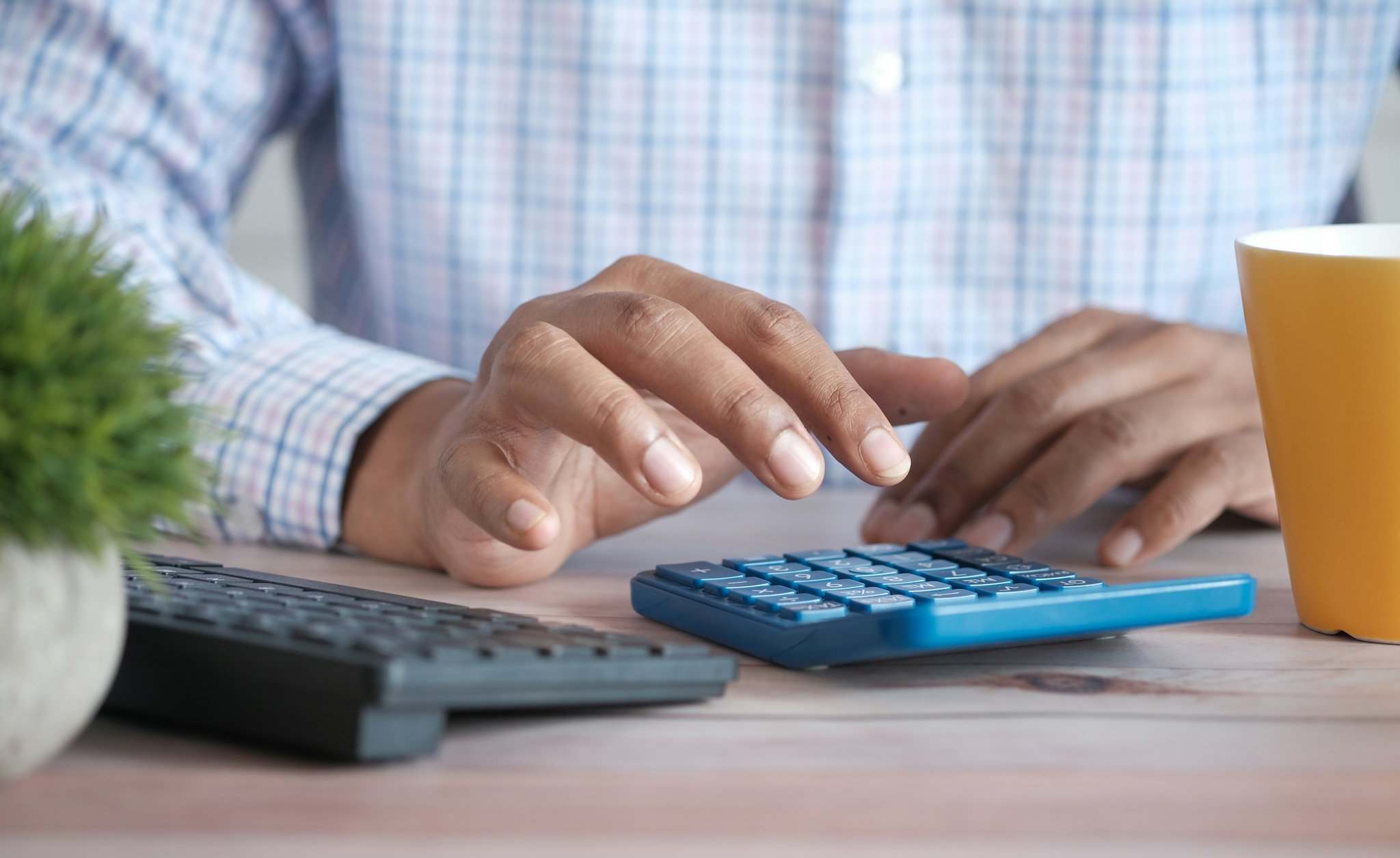 A person using a calculator representing tax calculation