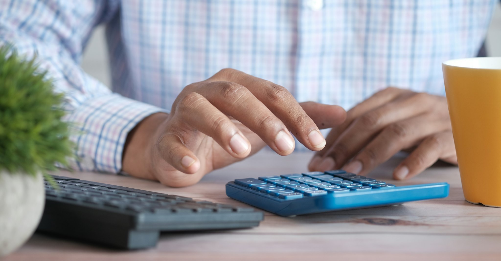 A person using a calculator representing tax calculation