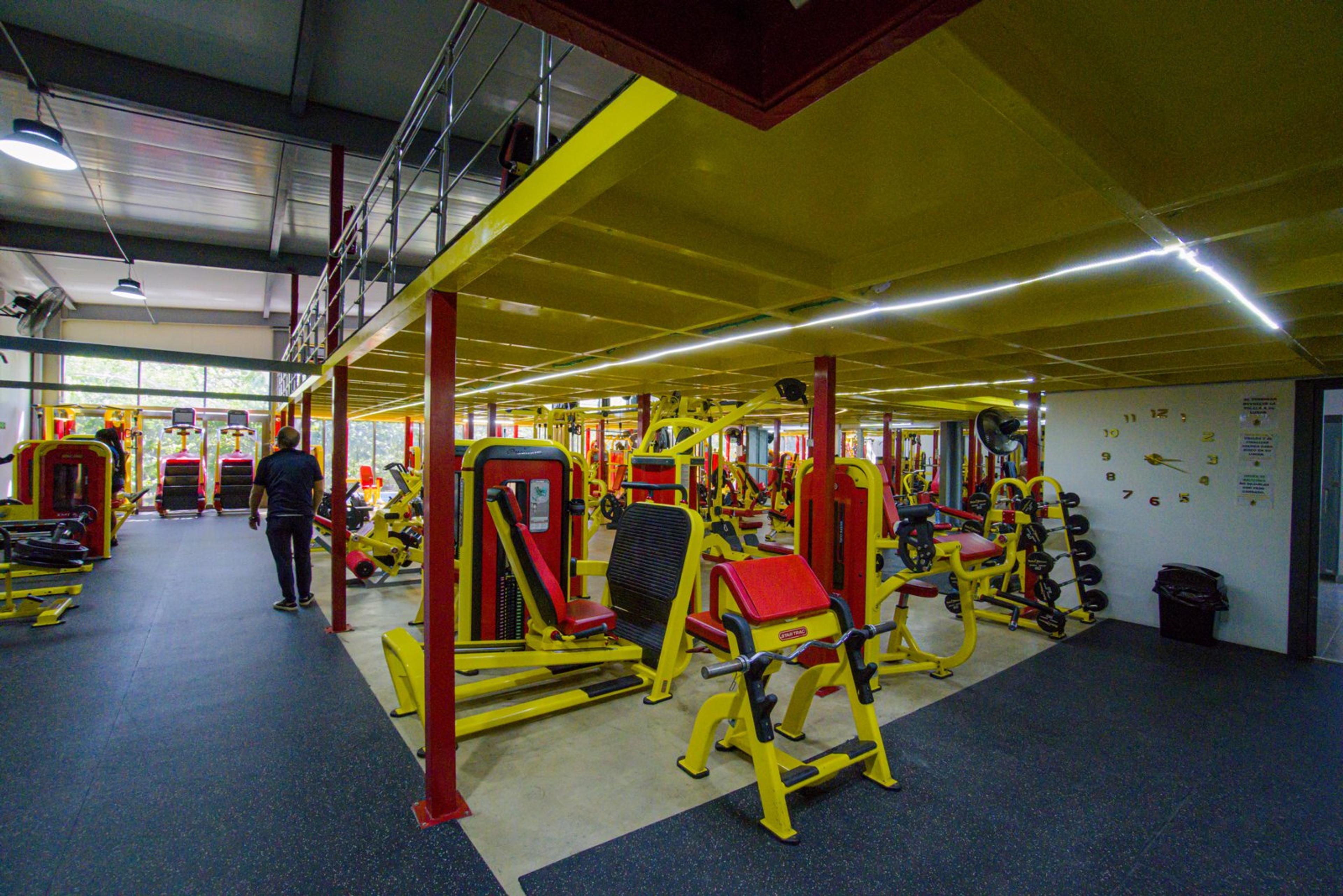 Shared gym with strength-training machines and weights