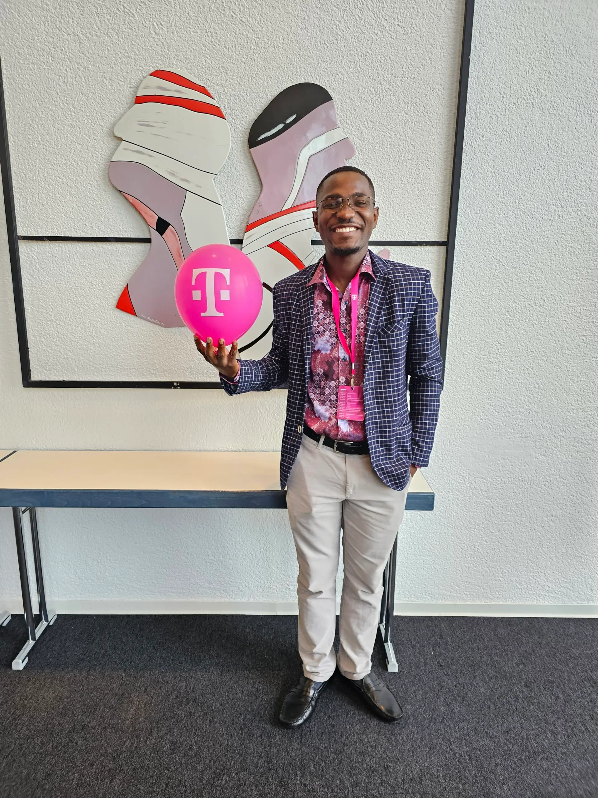 A person holding a balloon and smiling