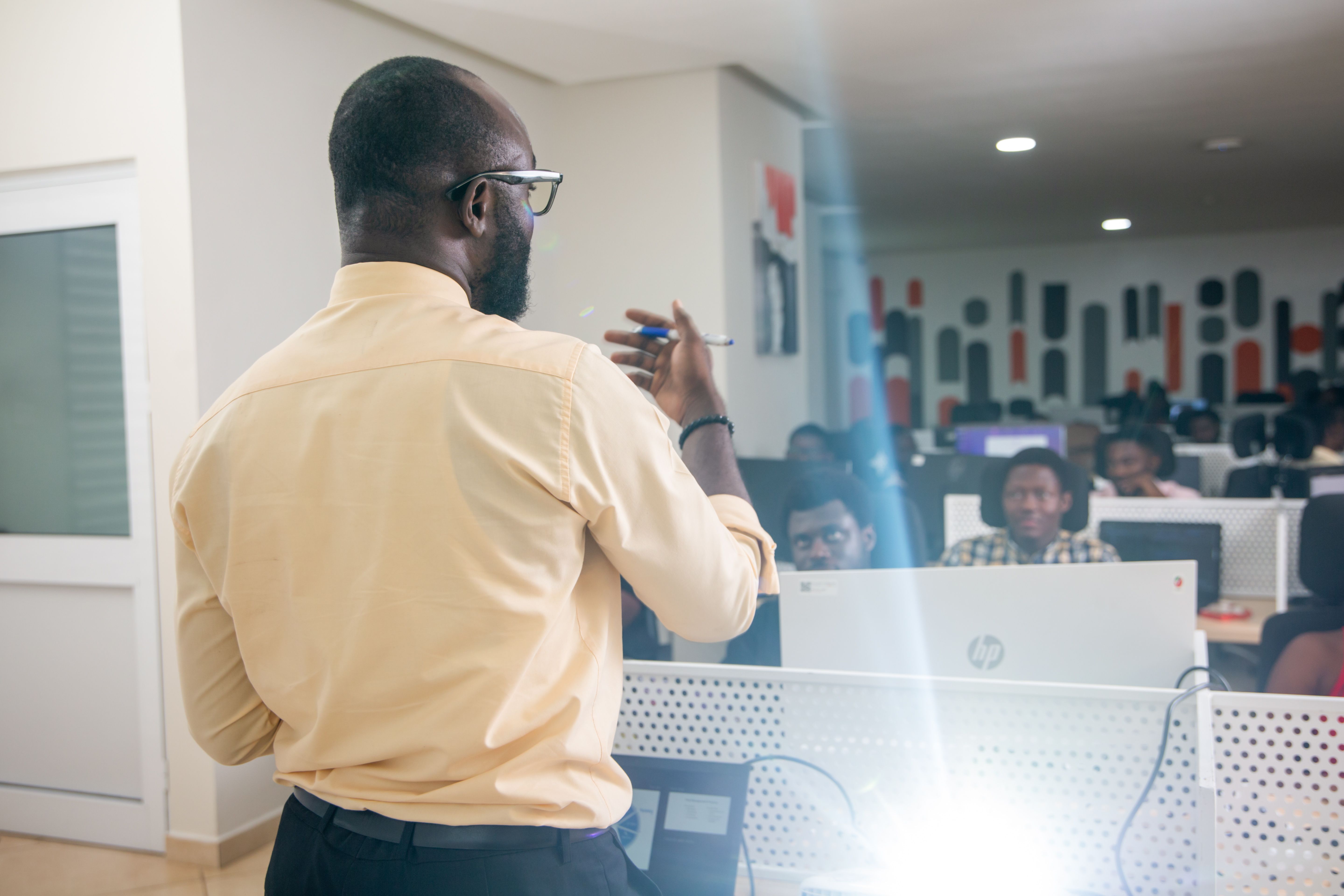 A teacher, presenting in front of a class.