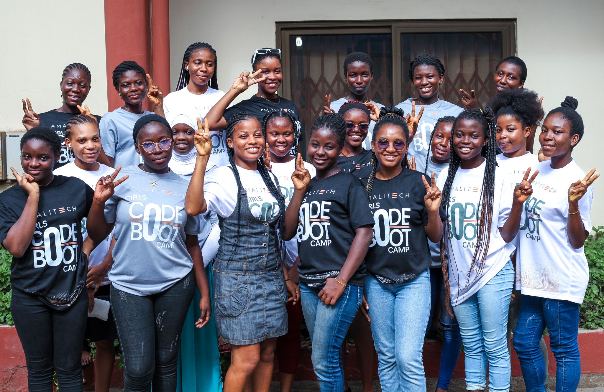 a group of women wearing "Girls Code Boocamp" tshirts, standing next to each other, smiling at the camera