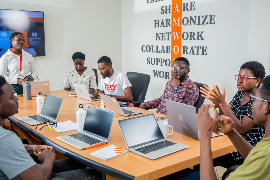 A team sitting at a conference table, in discussion