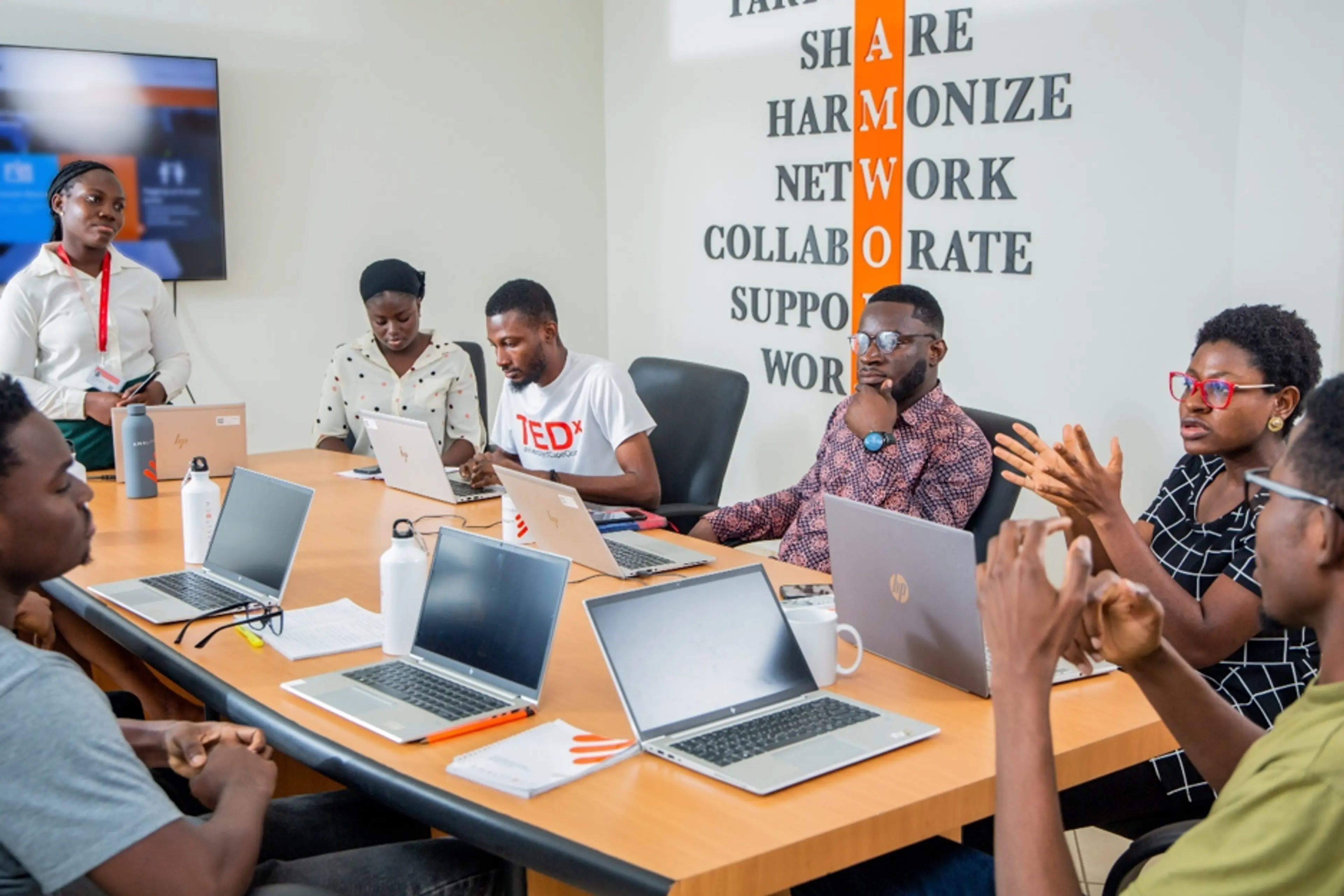 A team sitting at a conference table, in discussion