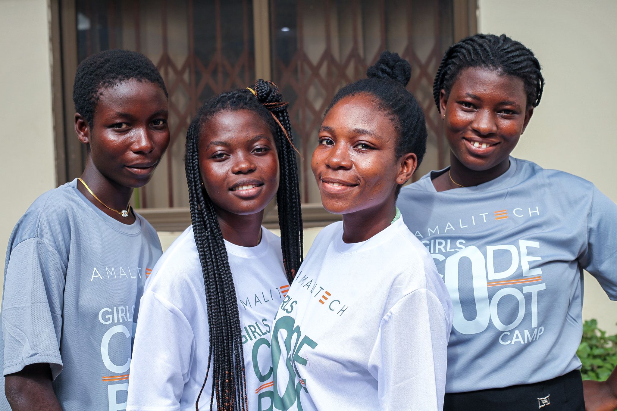 Four women wearing Girls Code Bootcamp tshirts, facing the camera