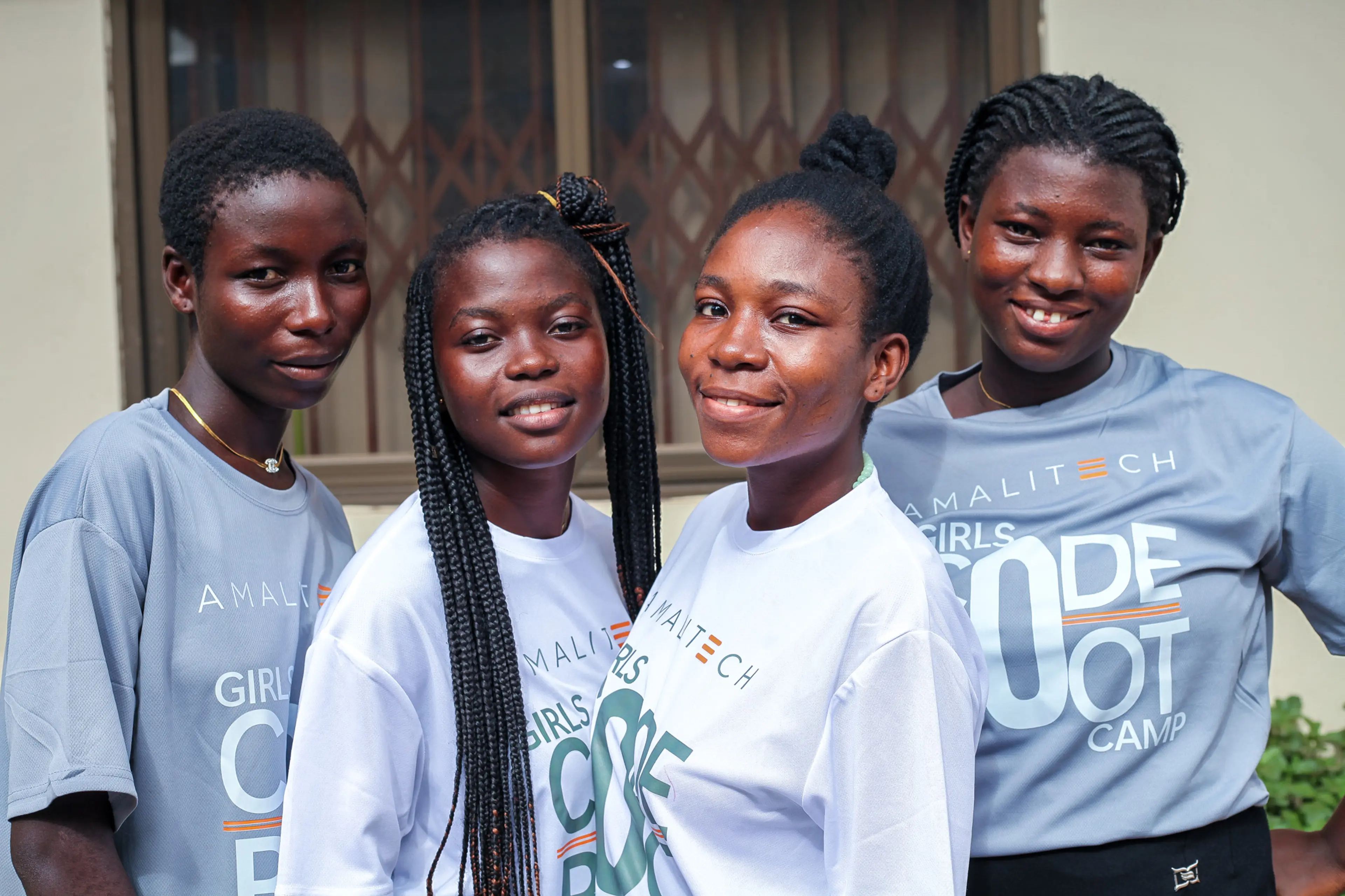 Four women wearing Girls Code Bootcamp tshirts, facing the camera