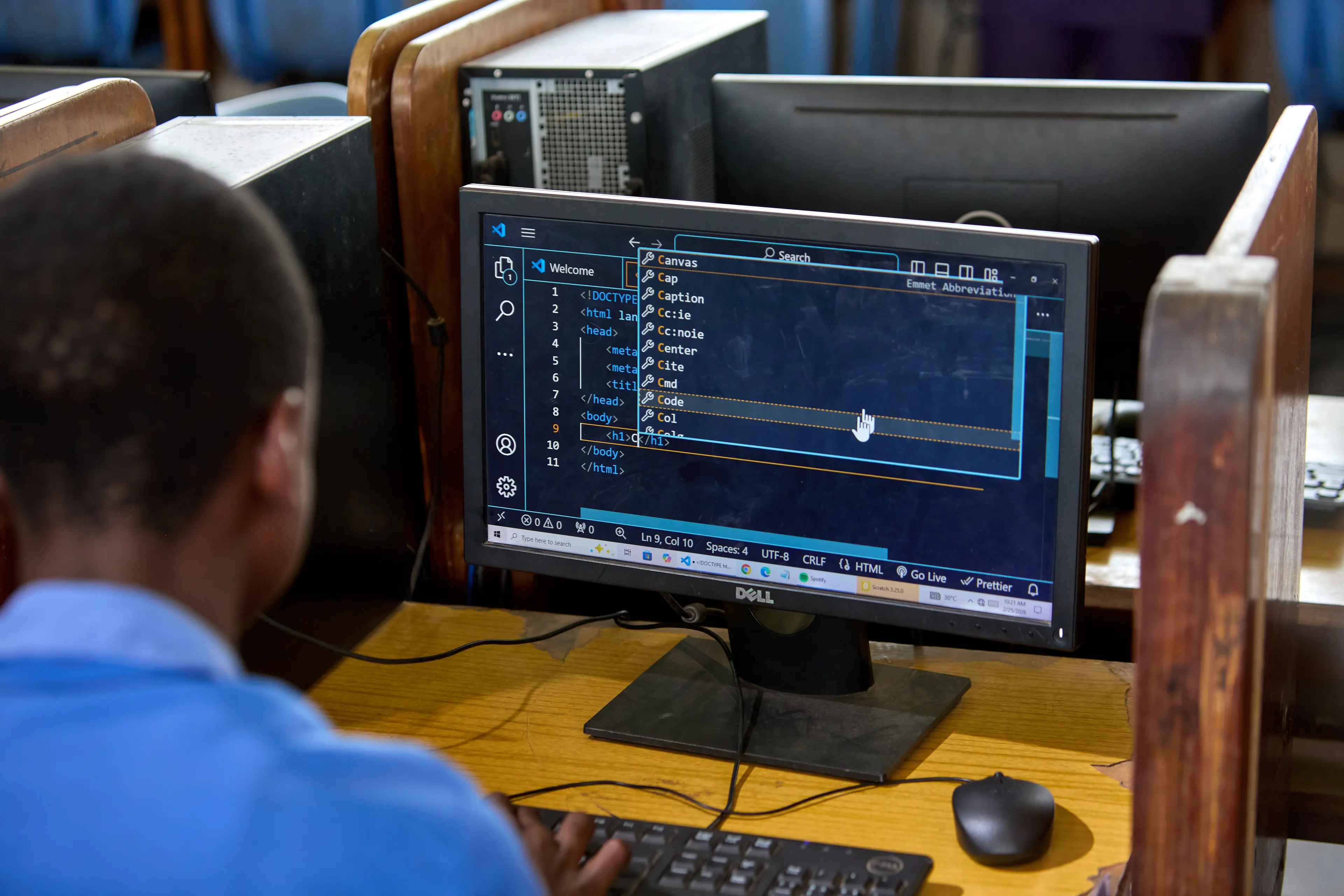An over the shoulder view of a boy working on his computer