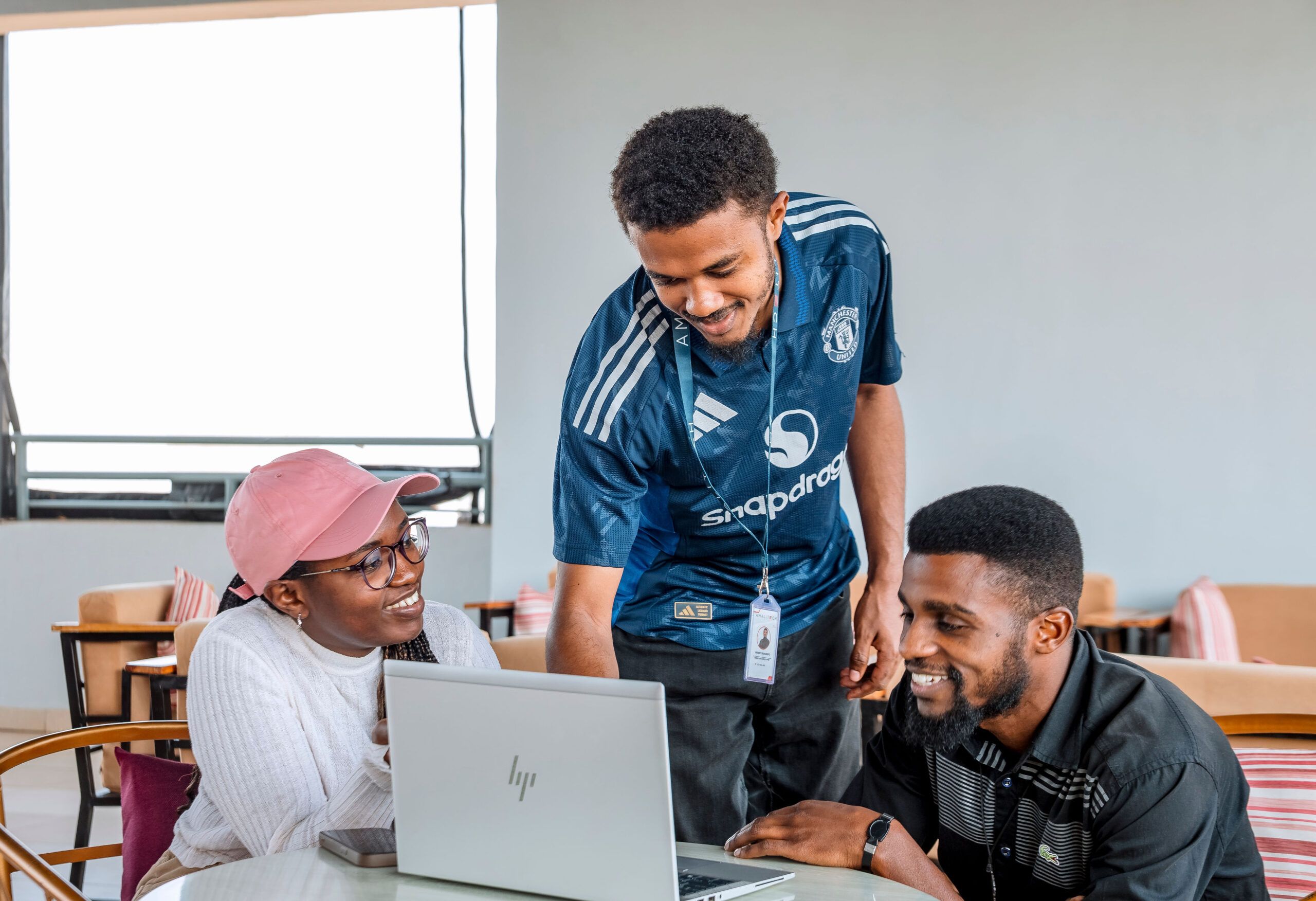 a young lady collaborating happily with two other guys