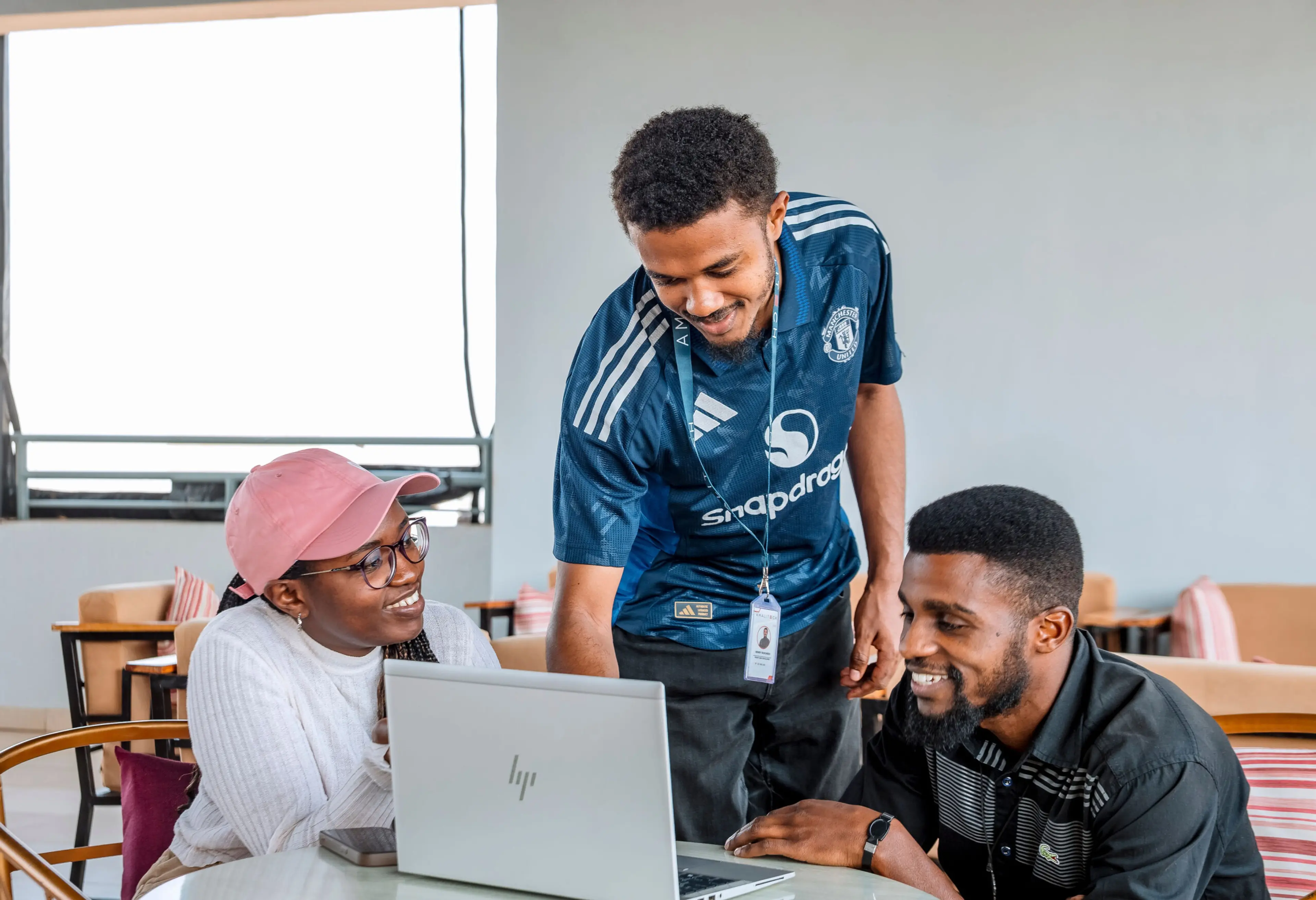 a young lady collaborating happily with two other guys